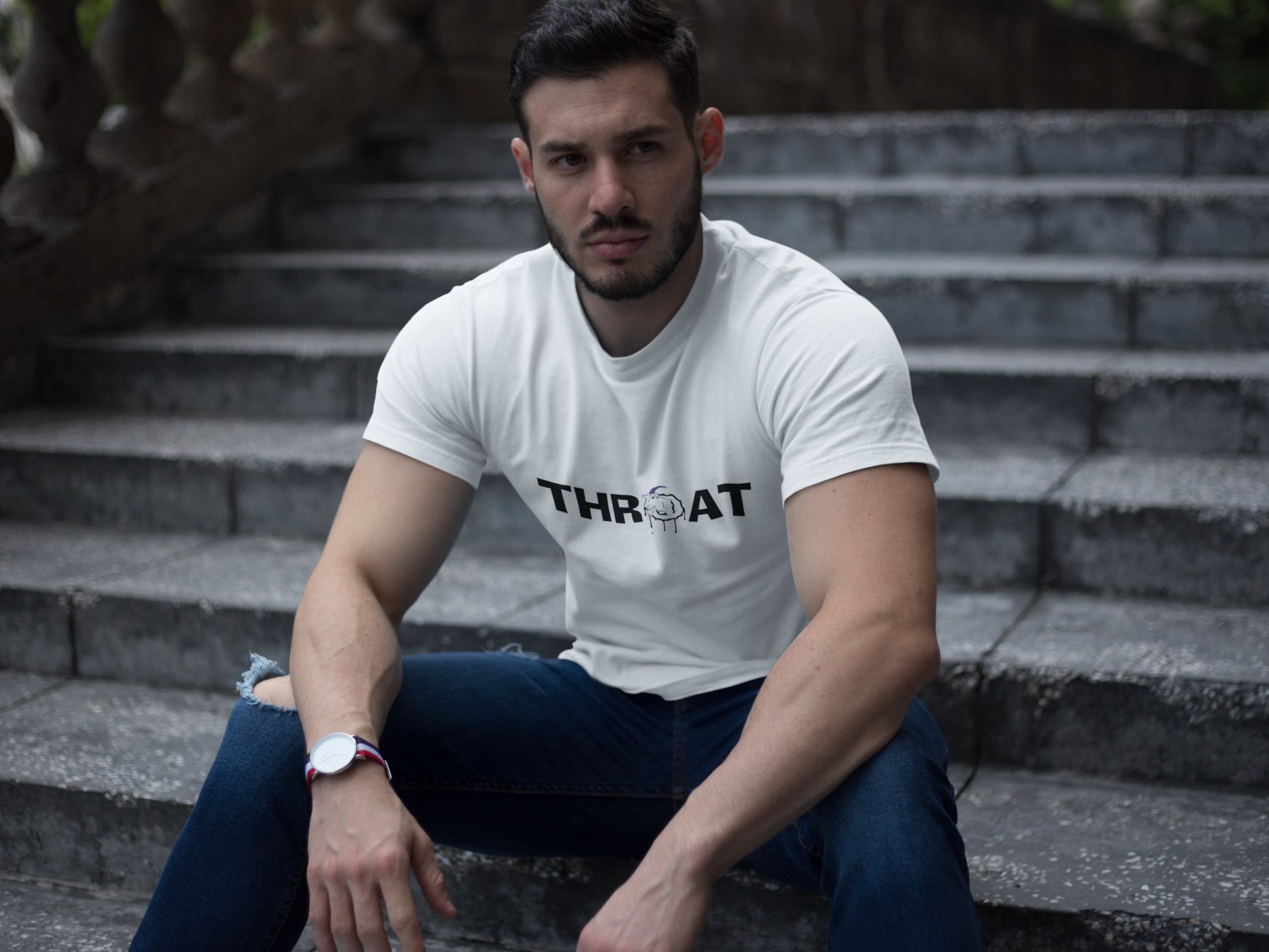 Model in a fitted white THROAT tee sitting on stairs