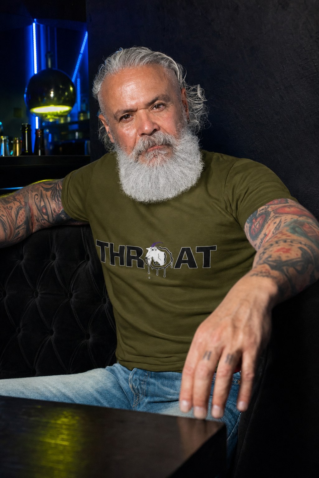 Man wearing a THROAT tee in a dark bar lounge