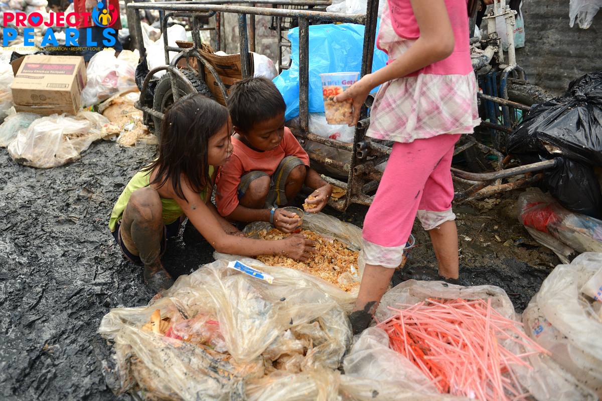 Children near discarded food and refuse