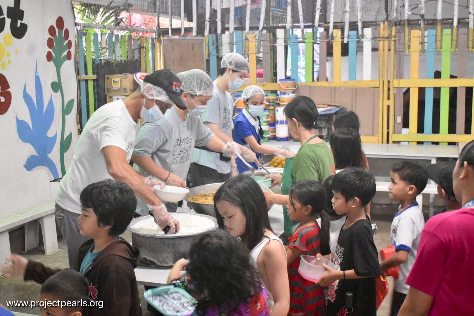 Volunteers serving a nourishing meal to children