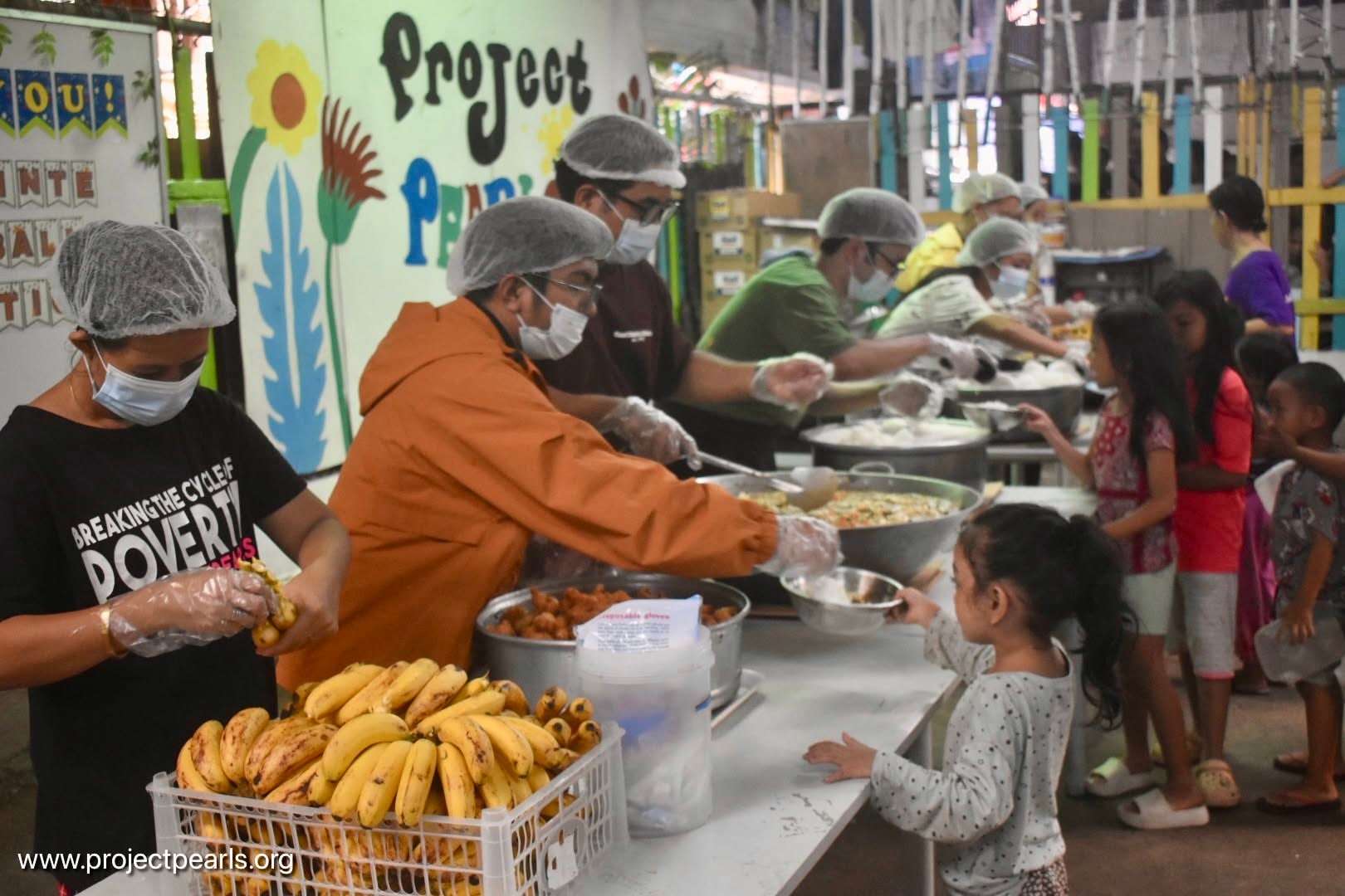 Project PEARLS volunteers serving food in a community meal program