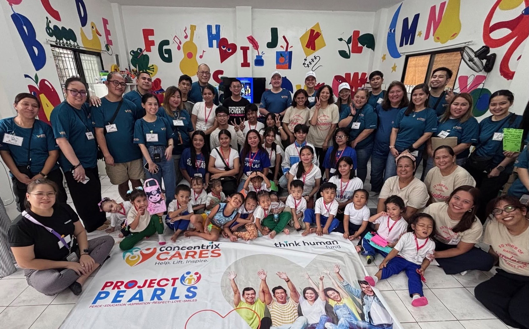 Concentrix Cares, Think Human Fund and Project PEARLS volunteers with children