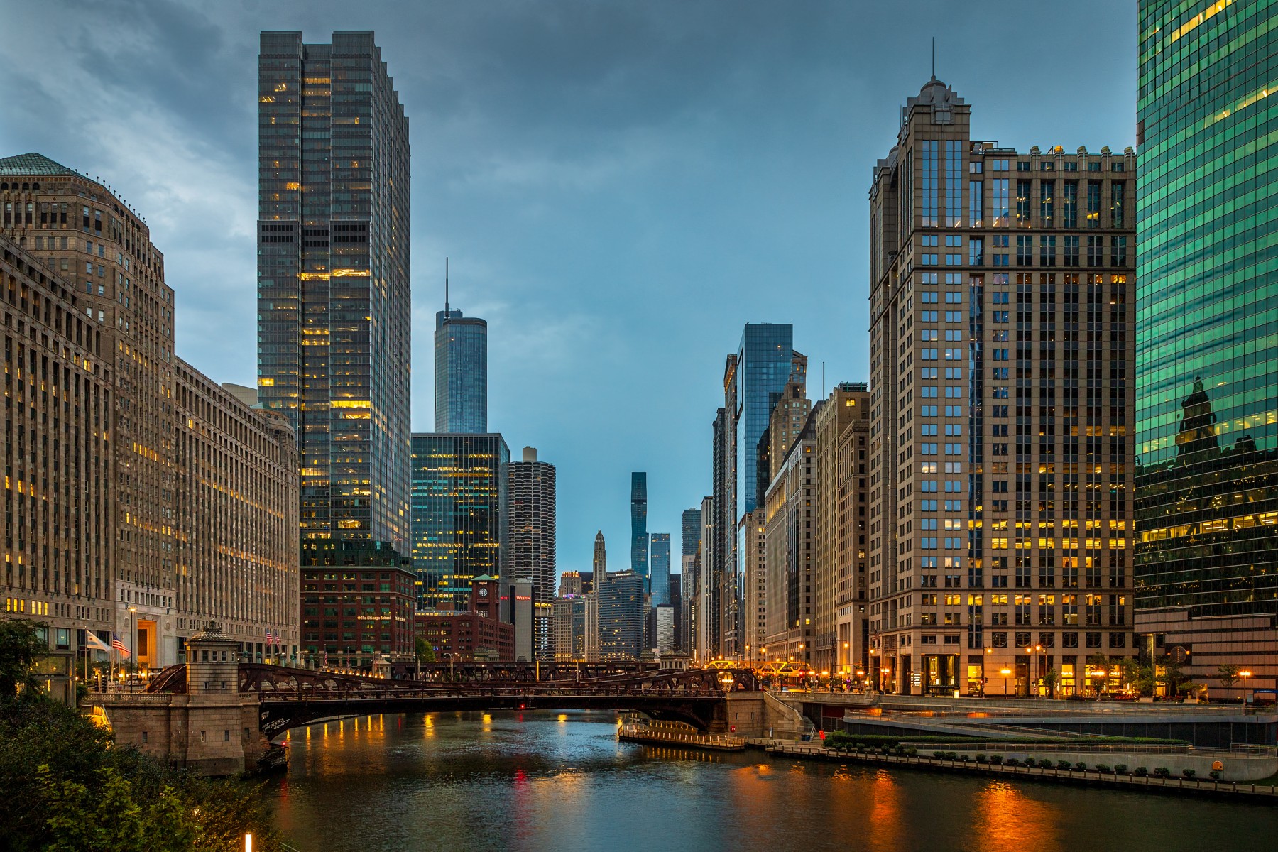 Chicago River at twilight, with bridges and illuminated downtown buildings