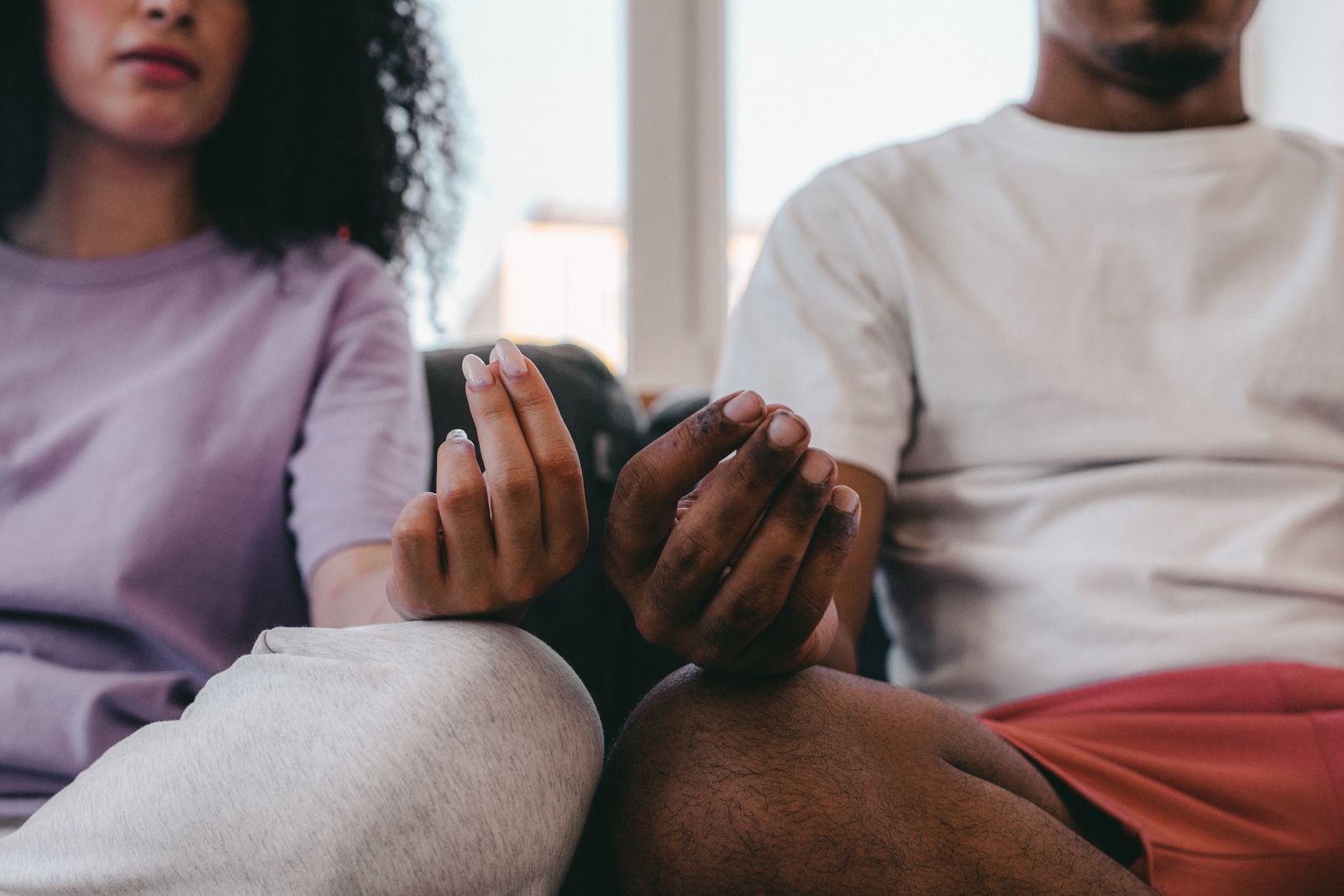 Couple practicing a quiet mindful breathing exercise together at home