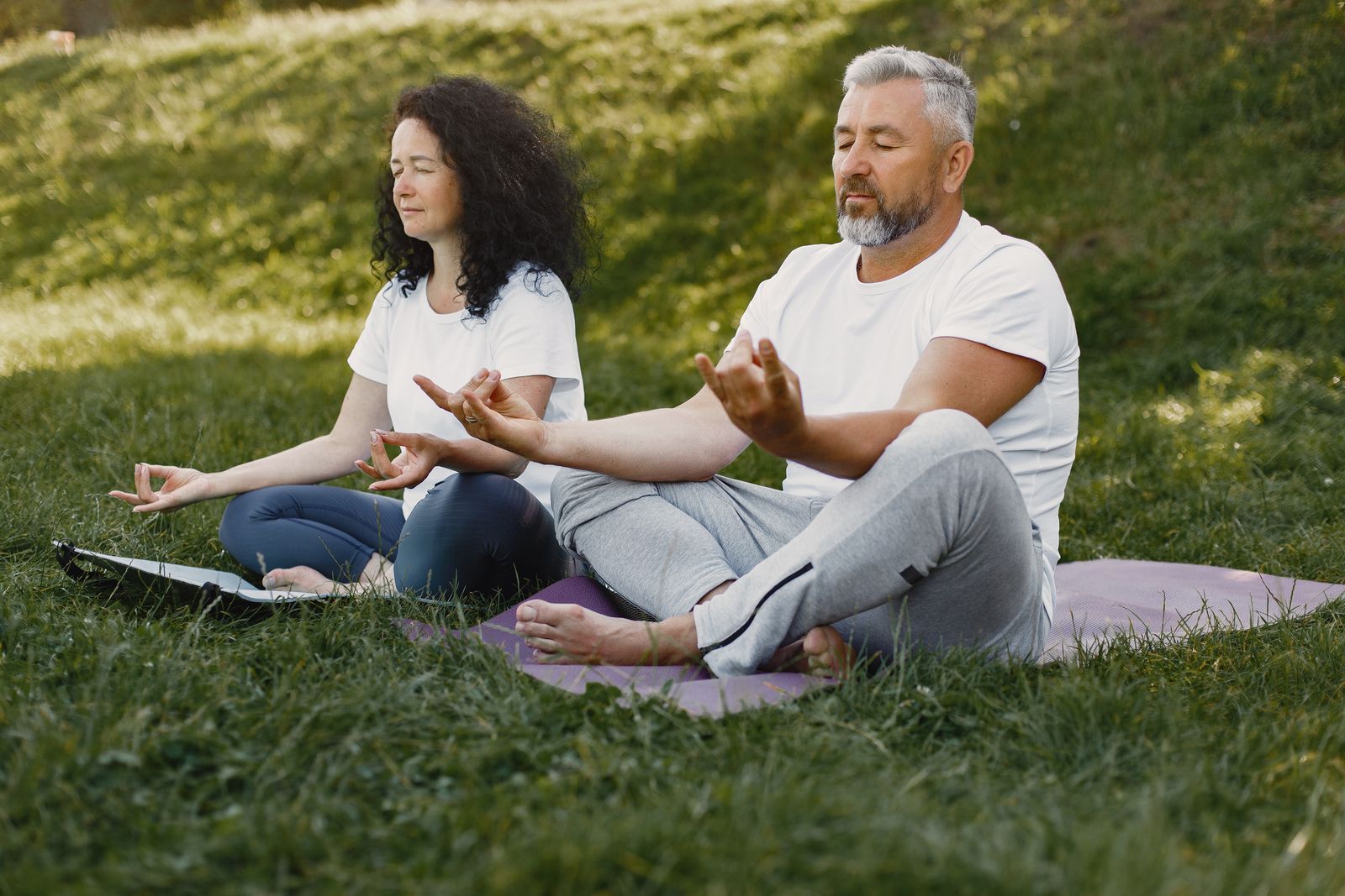 Couple practicing a shared outdoor breathing exercise