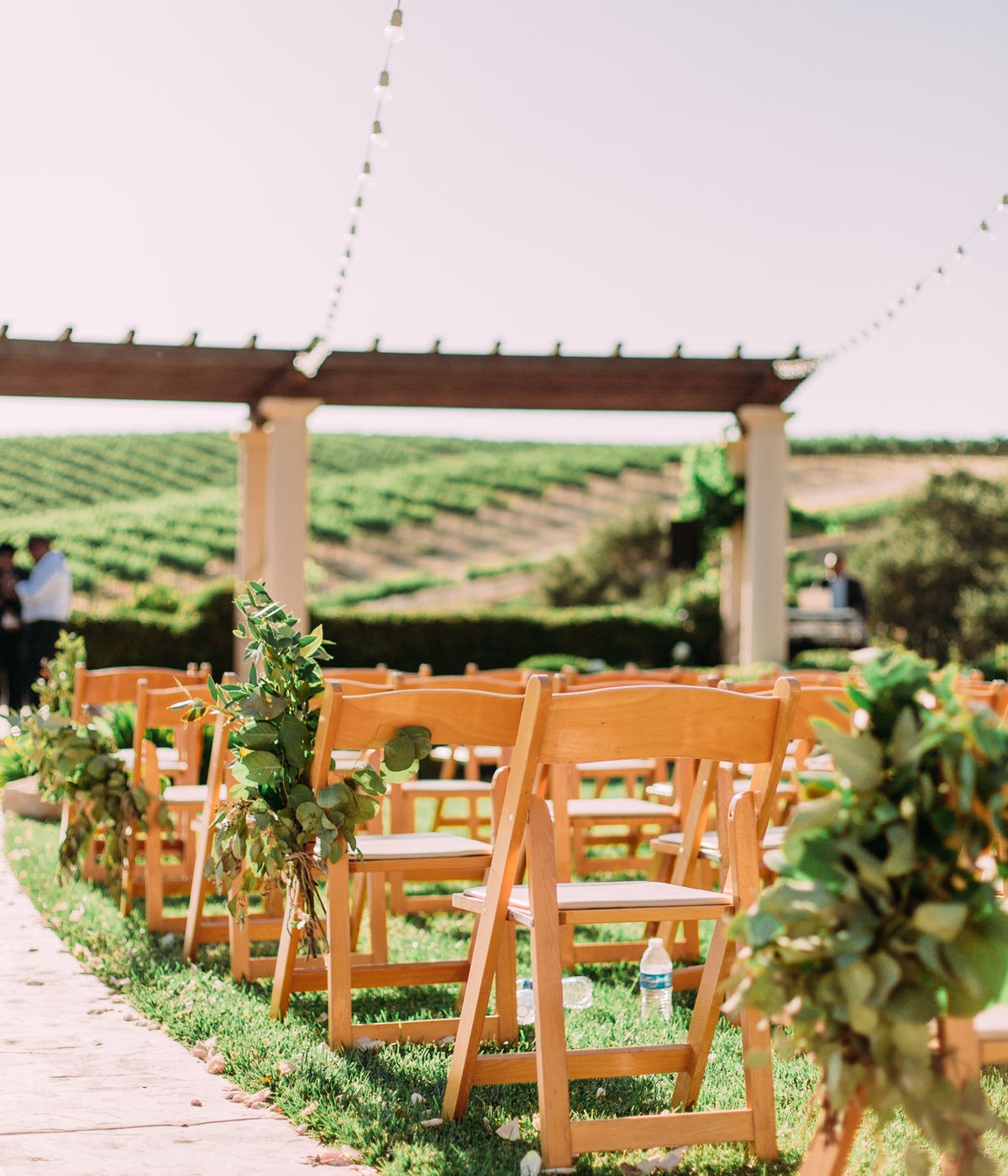 Outdoor wedding ceremony with guests and floral details