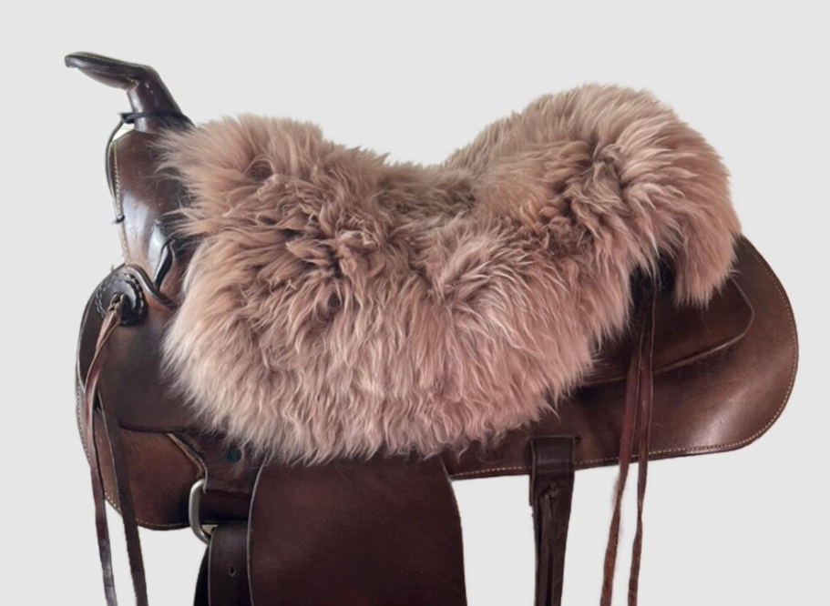 Brown sheepskin seat cover fitted over a Western saddle