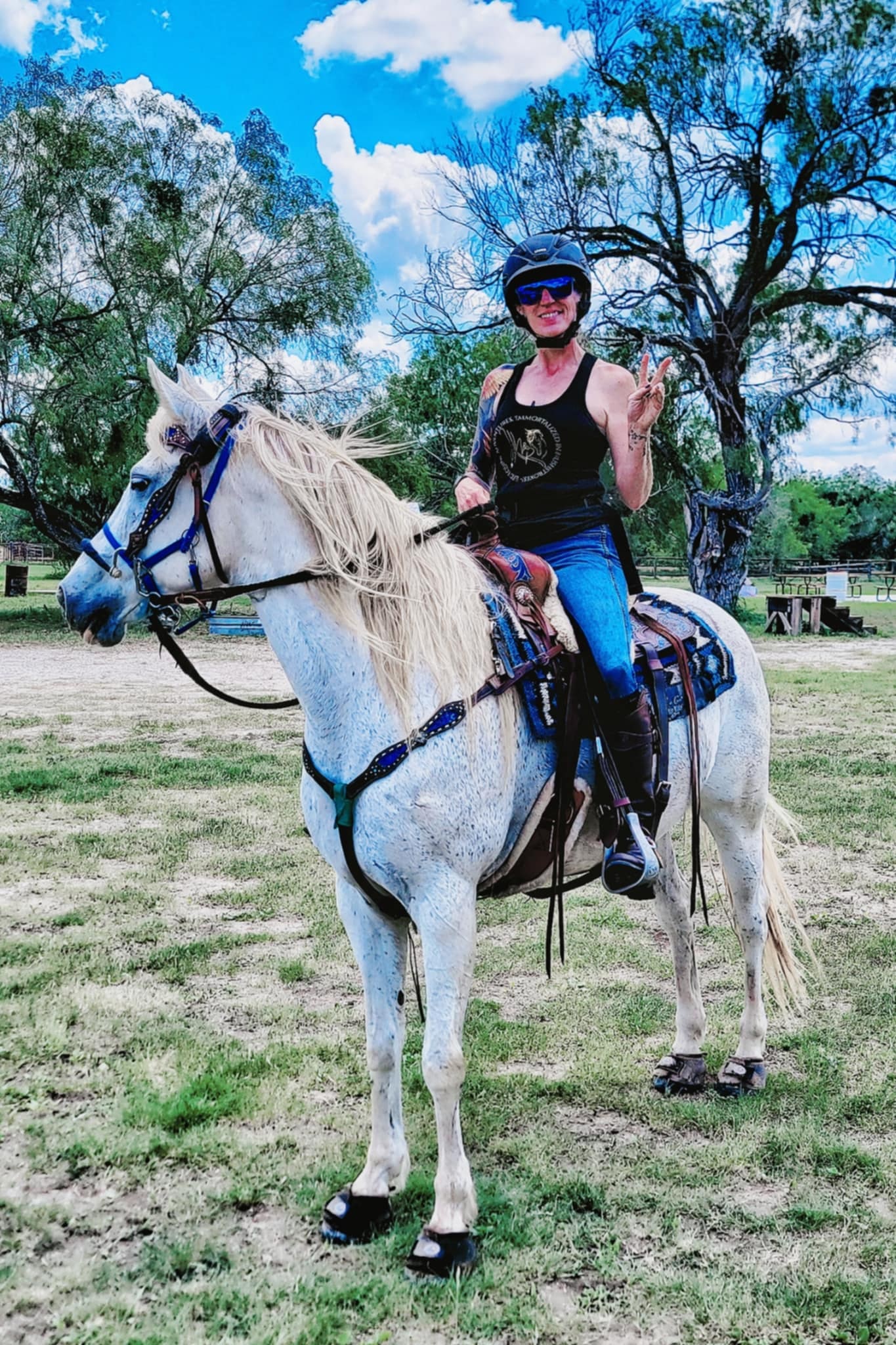 Nadine riding Ripley, a white horse