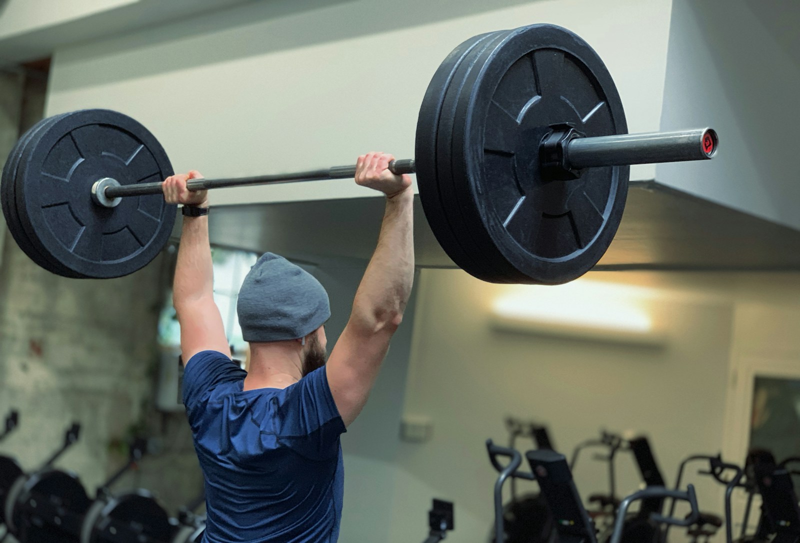 Athlete performing a controlled barbell lift in a gym