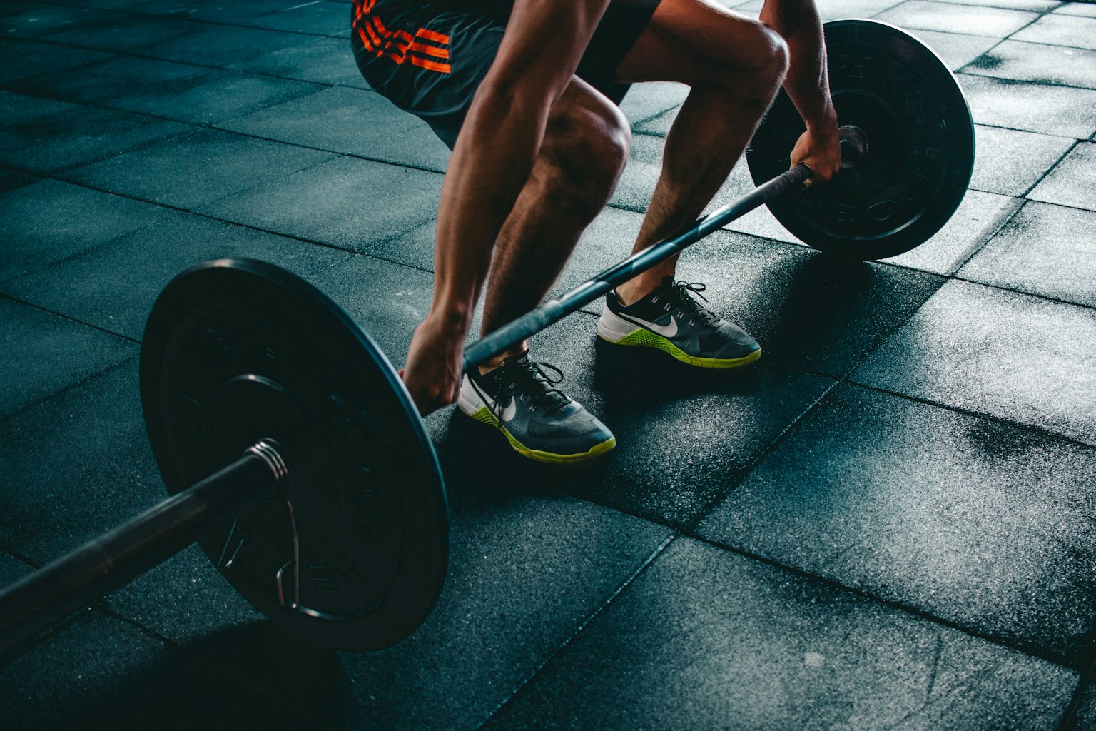 Athlete setting up for a barbell lift in a training gym