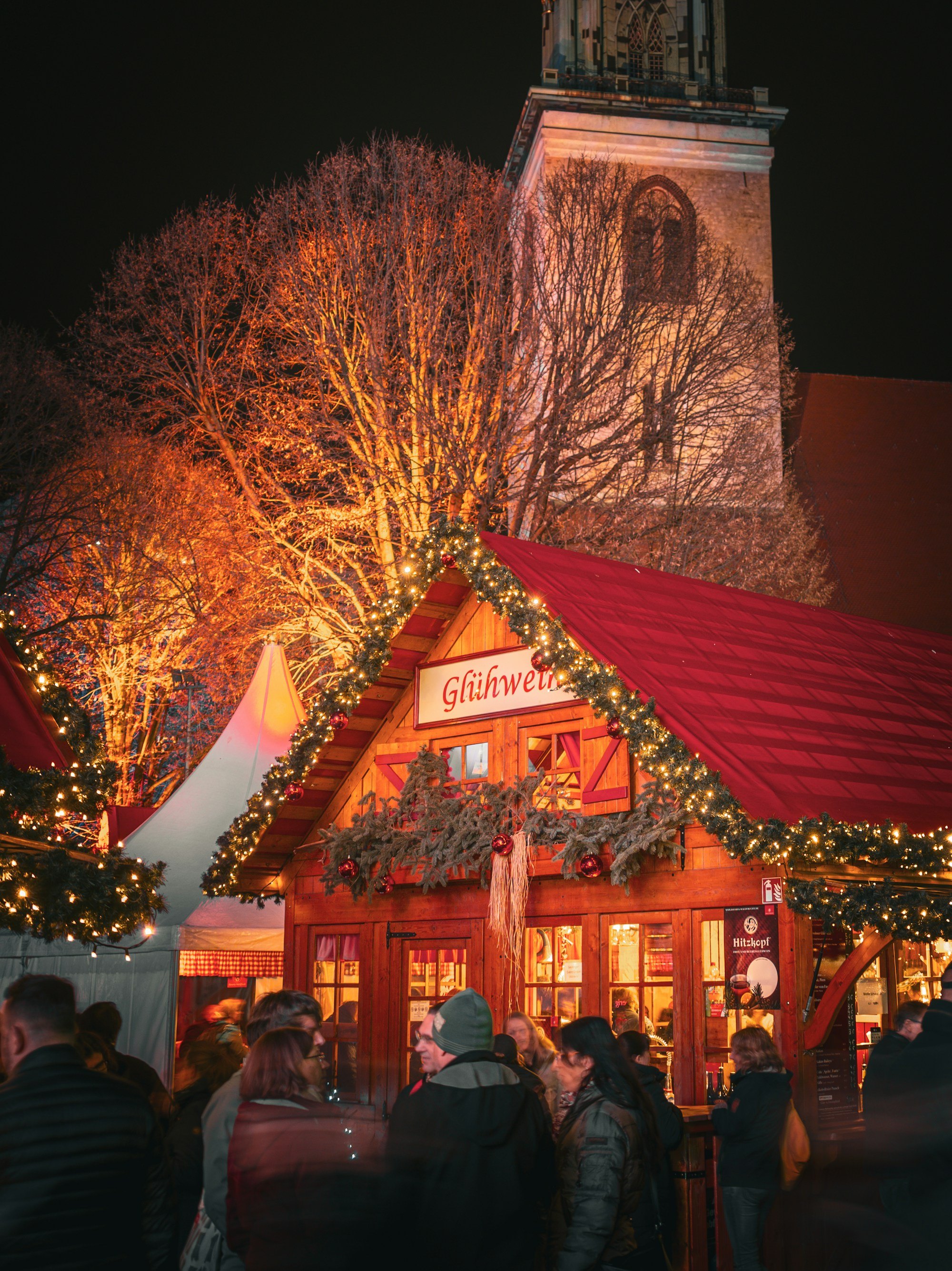 Glowing Christmas market stalls beneath festive lights in Berlin, Germany