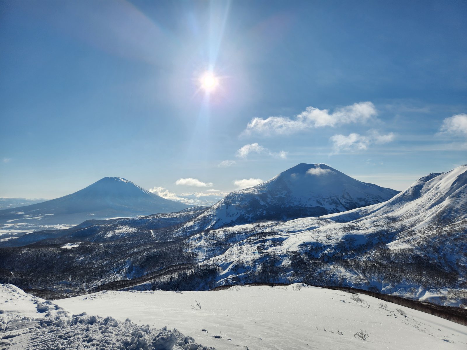 Snow-covered Mount Yotei and Niseko Annupuri viewed from Mount Weisshorn in Hokkaido