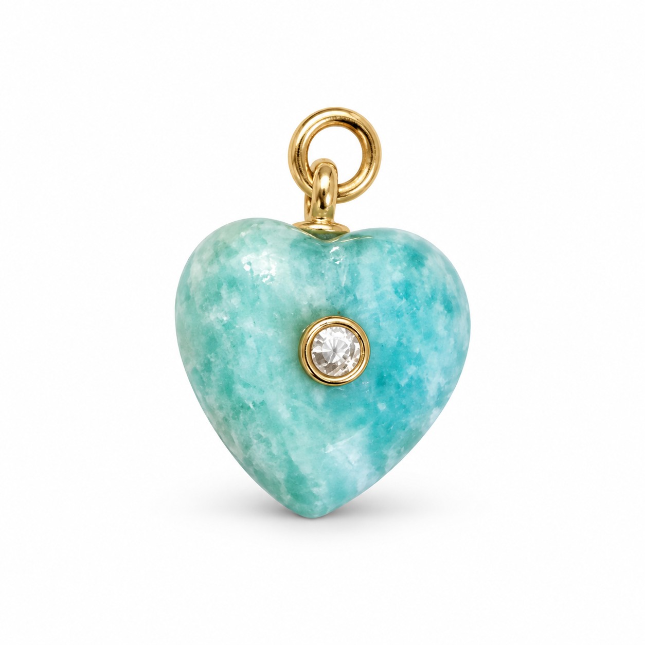 Gold-tone pendant jewelry arranged on a warm ivory surface