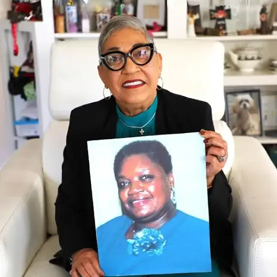 Rev. Sharon Risher holding a portrait of her mother, Ethel Lance