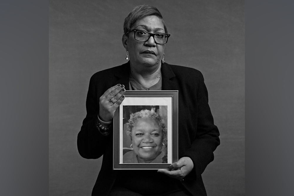 Reverend Sharon Risher holding a portrait of her mother, Ethel Lance.