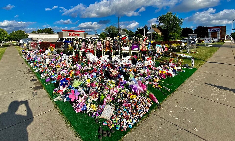 Flowers and portraits at the memorial outside Tops Markets on Jefferson Avenue