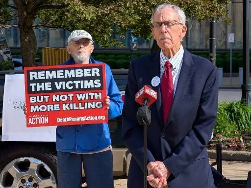 Coalition members holding signs outside the Buffalo federal courthouse