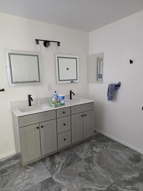 Bright finished kitchen with gray cabinetry