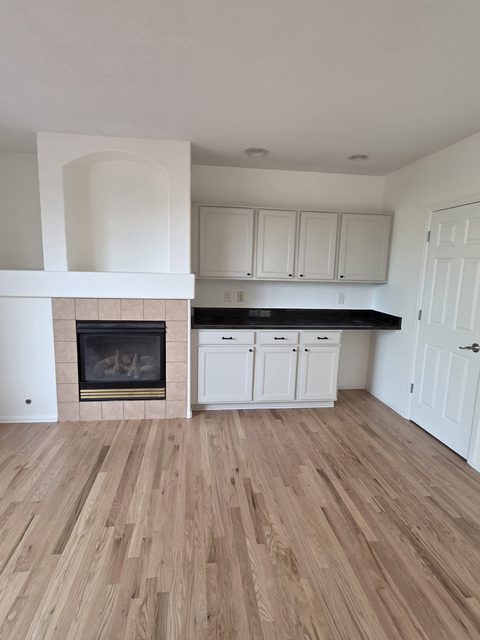 Finished open-plan kitchen with white painted cabinetry