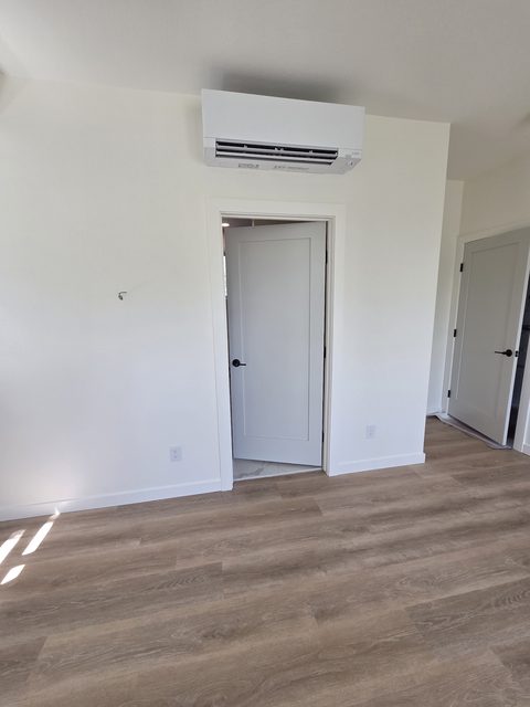 Bright finished interior with white trim and wood flooring
