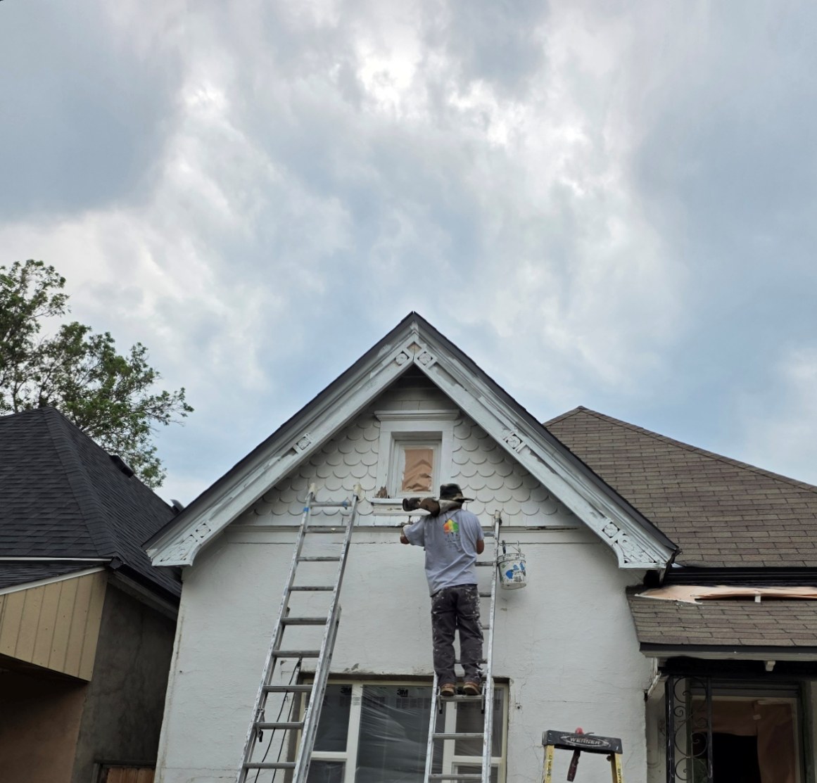 Welchez Painting team member preparing an exterior home's trim