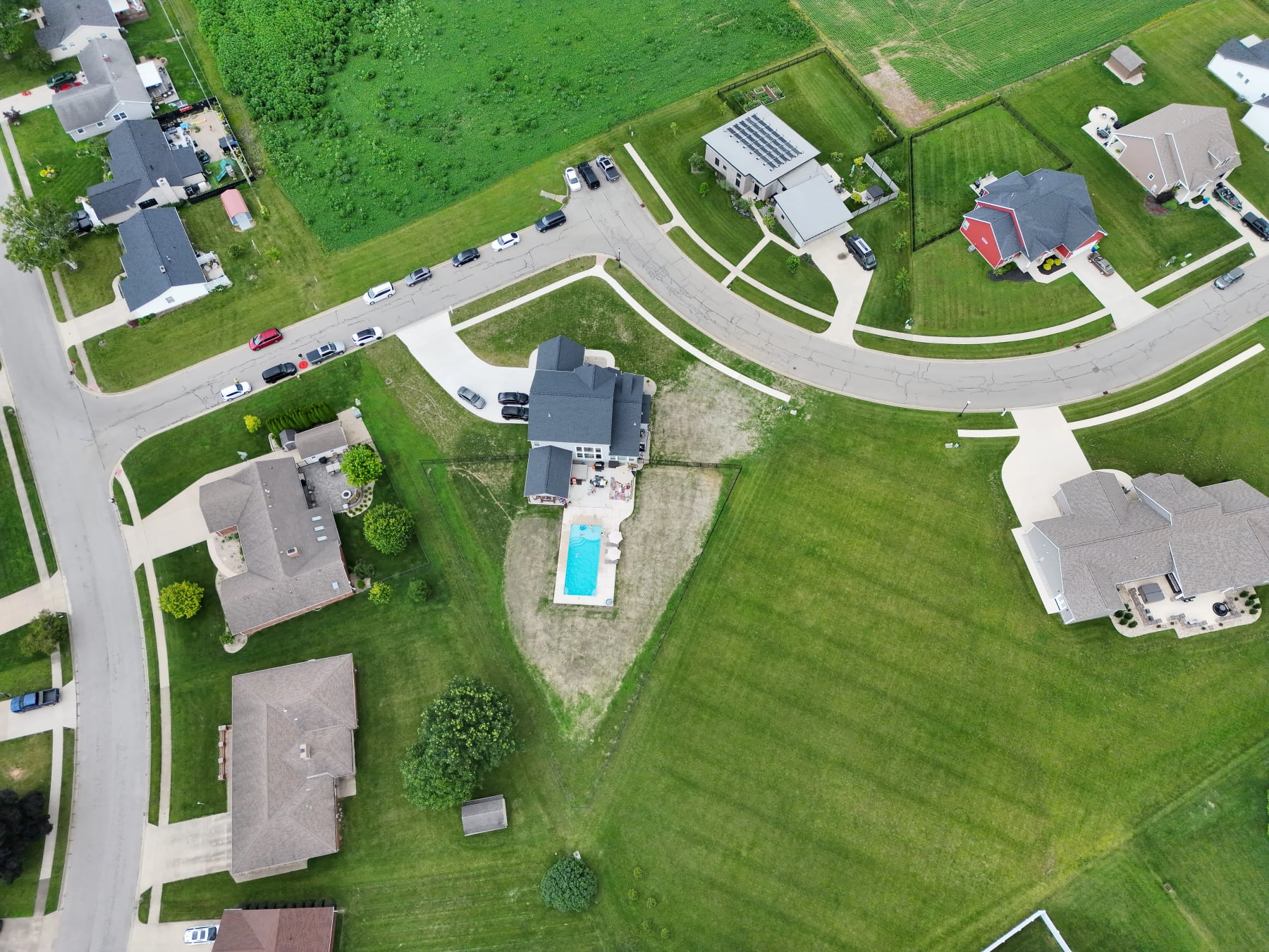 Overhead aerial view showing a residential property and nearby homes