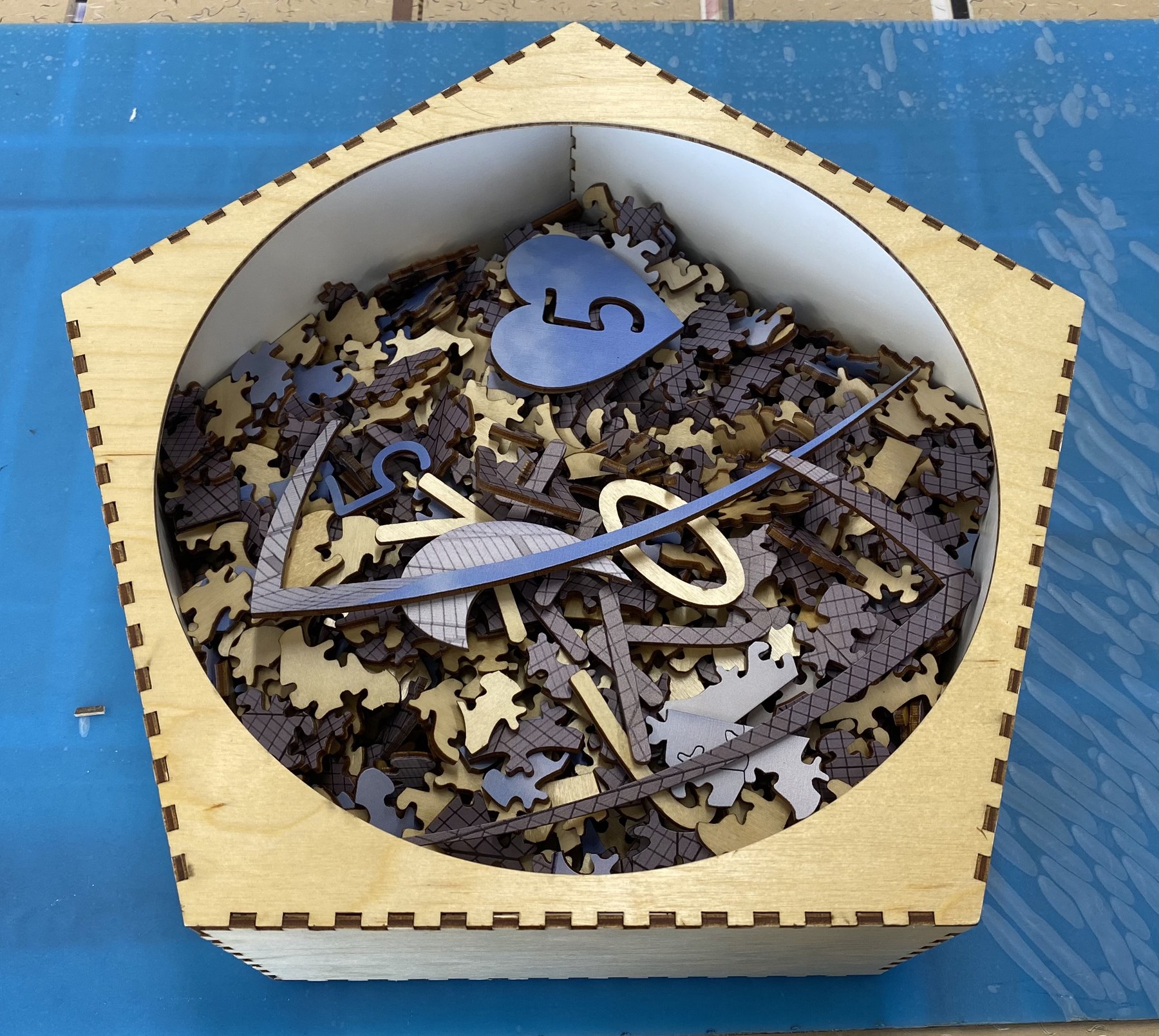 A laser-cut layered puzzle set in its custom wooden box