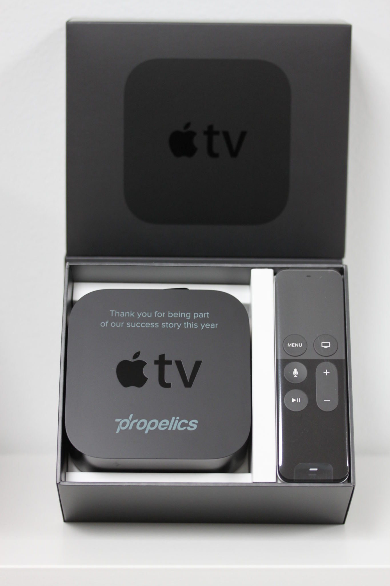 A branded Apple TV set presented in its original packaging