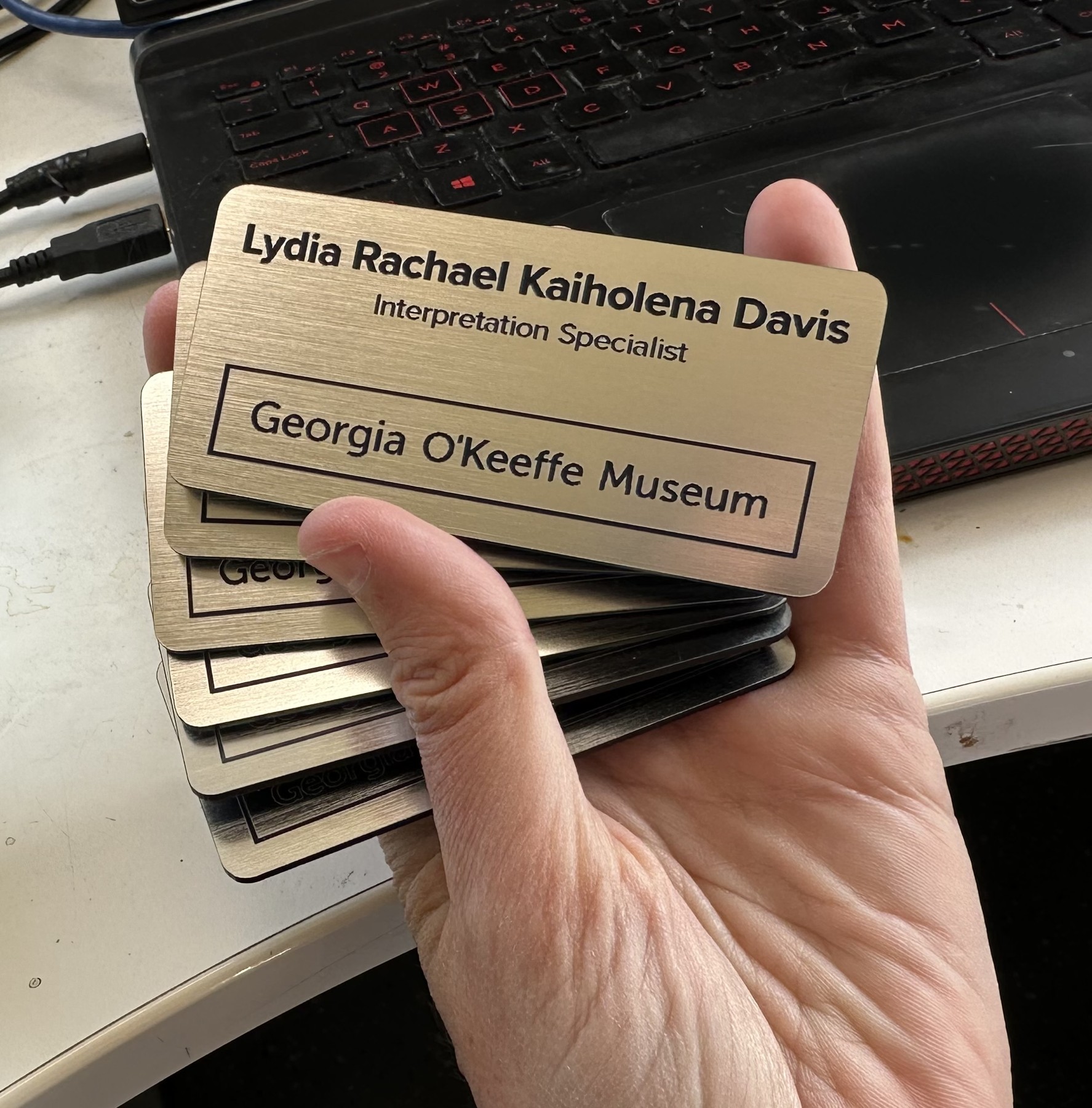 Georgia O’Keeffe Museum gold-finish plastic name badges with magnetic backs