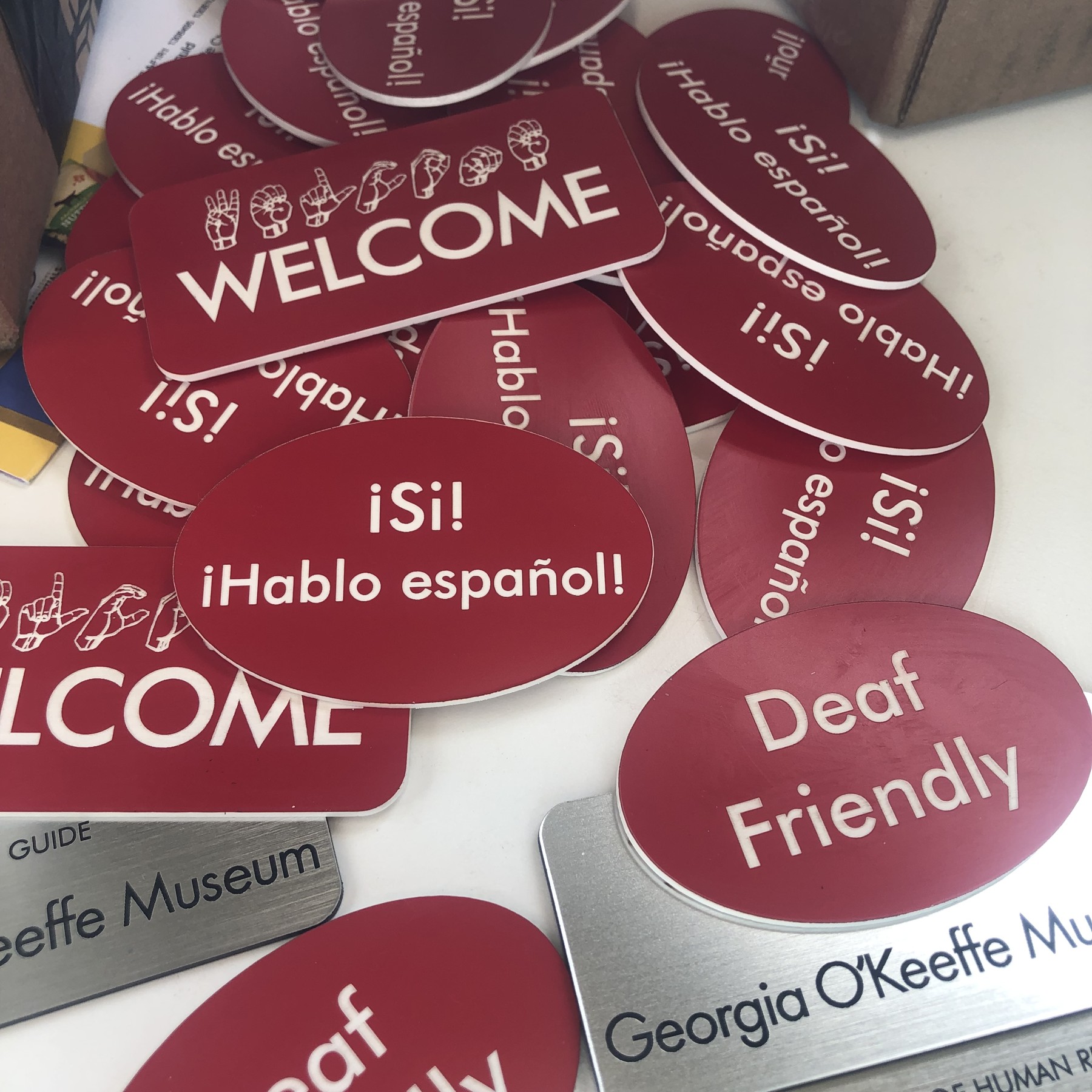 Museum language and welcome plastic badges with magnetic backs