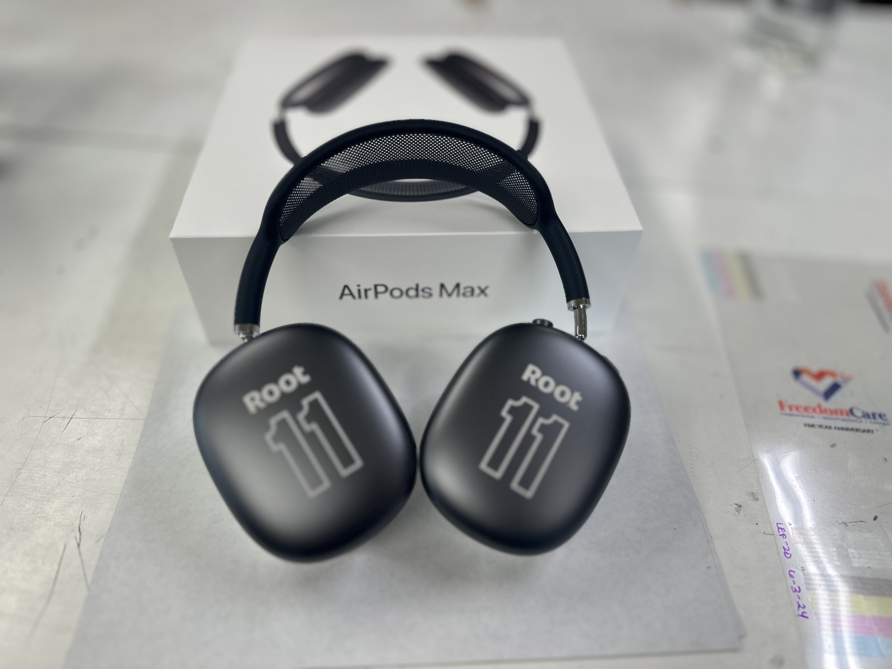 Root 11 design engraved on AirPods Max ear cups