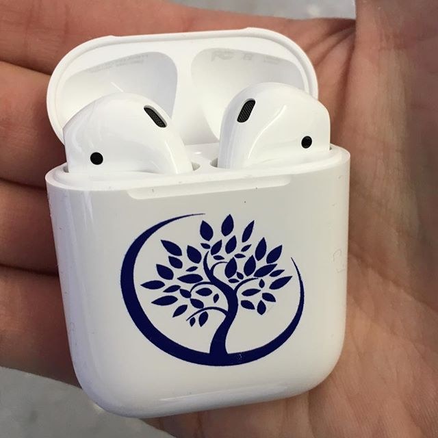 Custom printed AirPods case held open to show the finished mark
