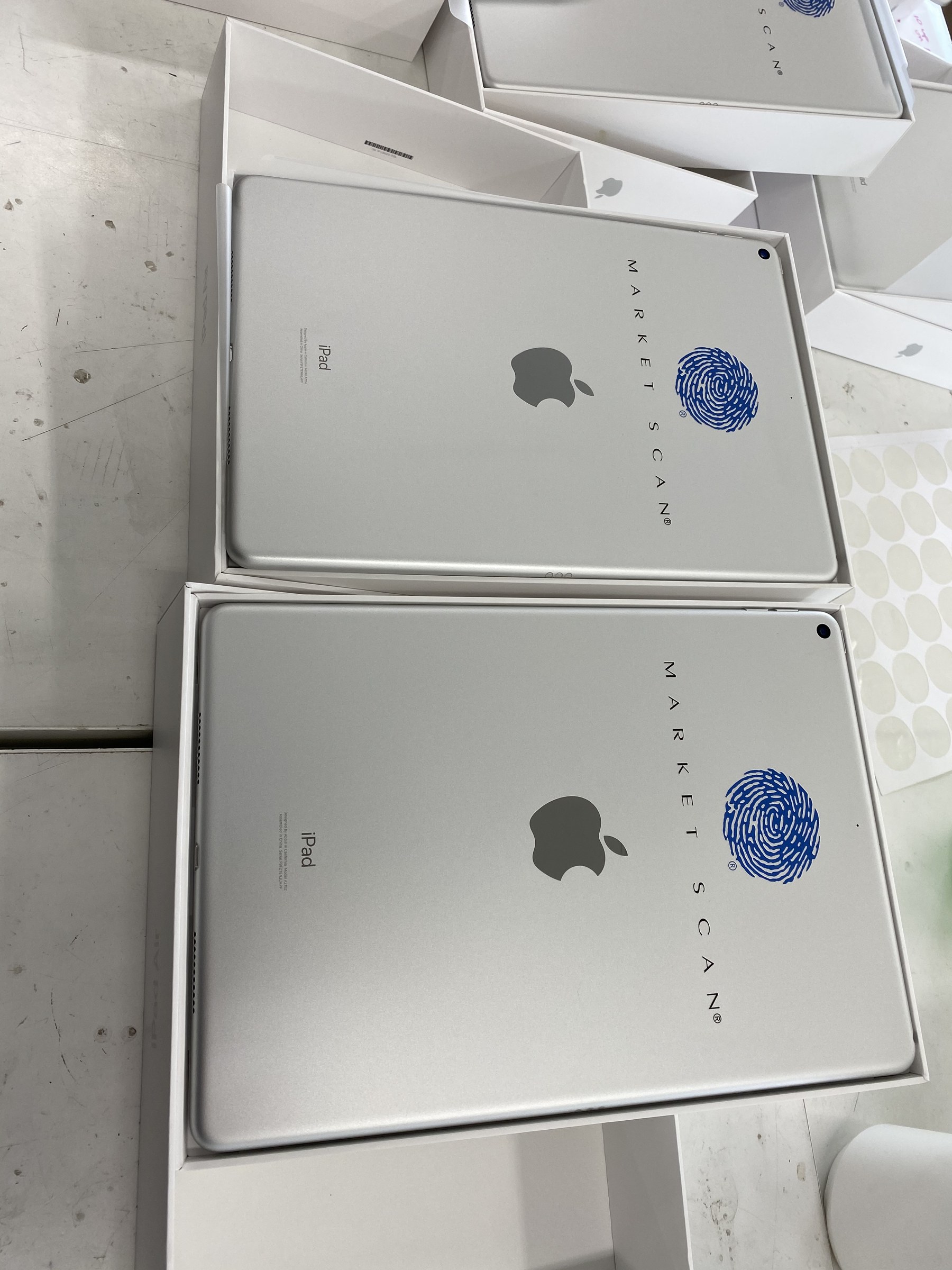 A batch of marked iPads in their original boxes