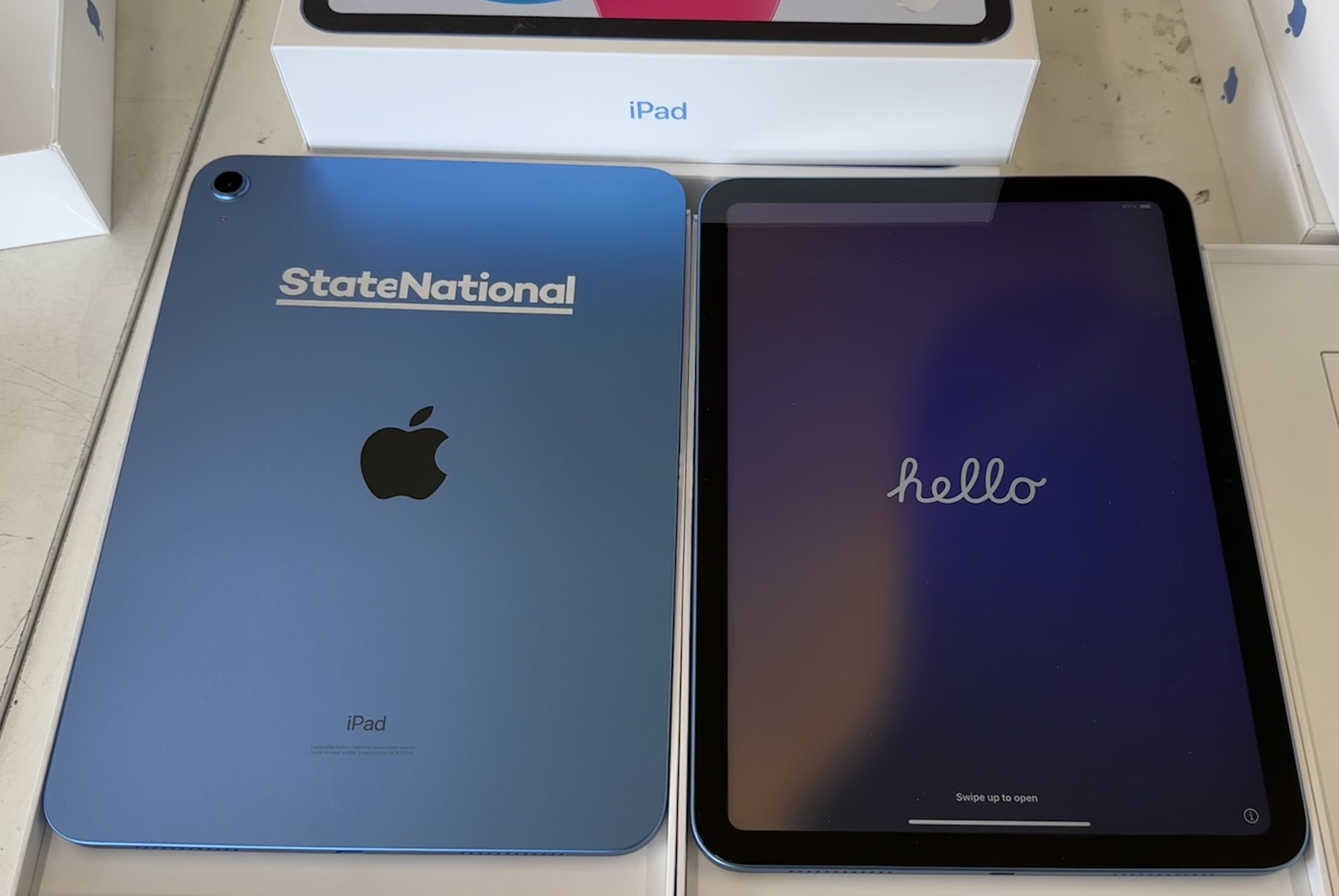 Two custom-marked iPads prepared for a corporate deployment