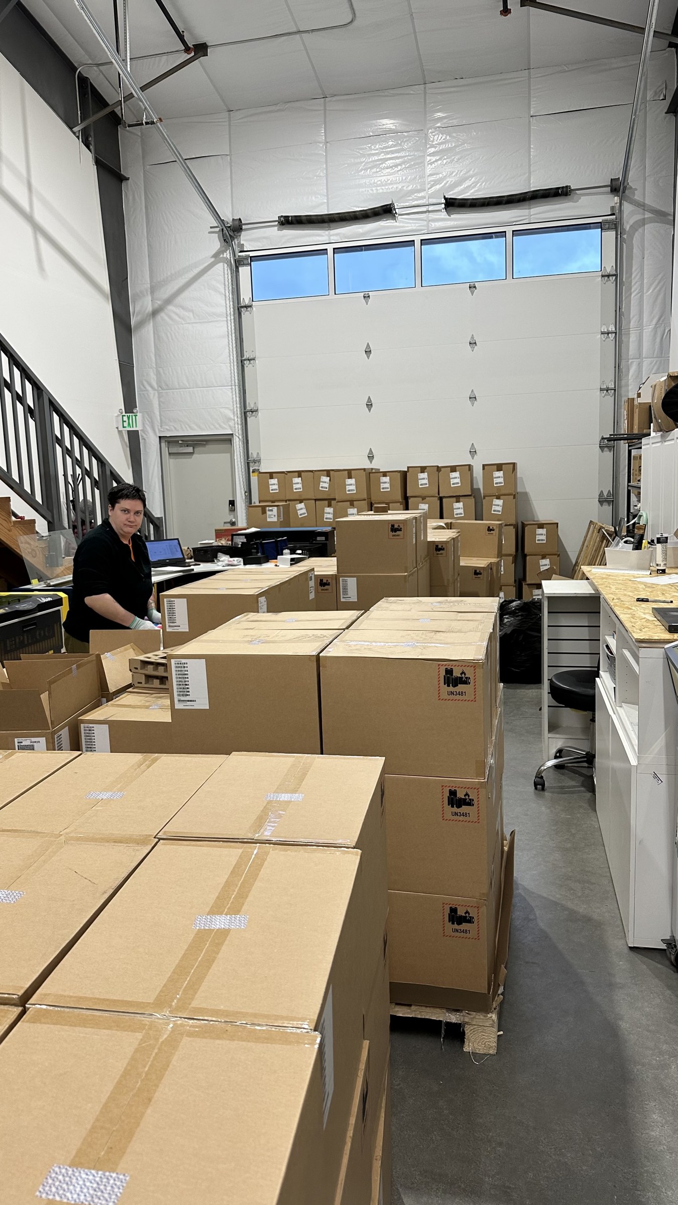 Organized boxes staged in the In A Flash Laser warehouse