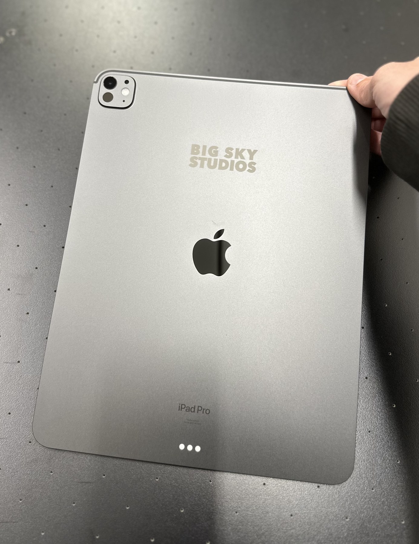 A branded iPad showing a precise laser-marked logo