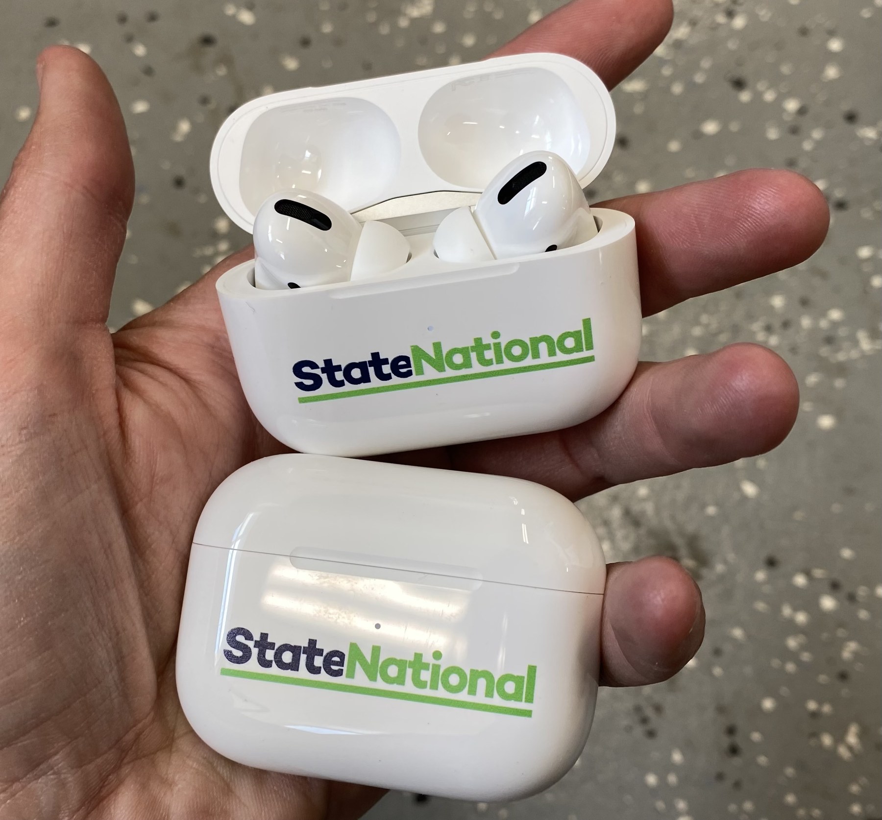 A custom-branded AirPods case with a full-color State National logo