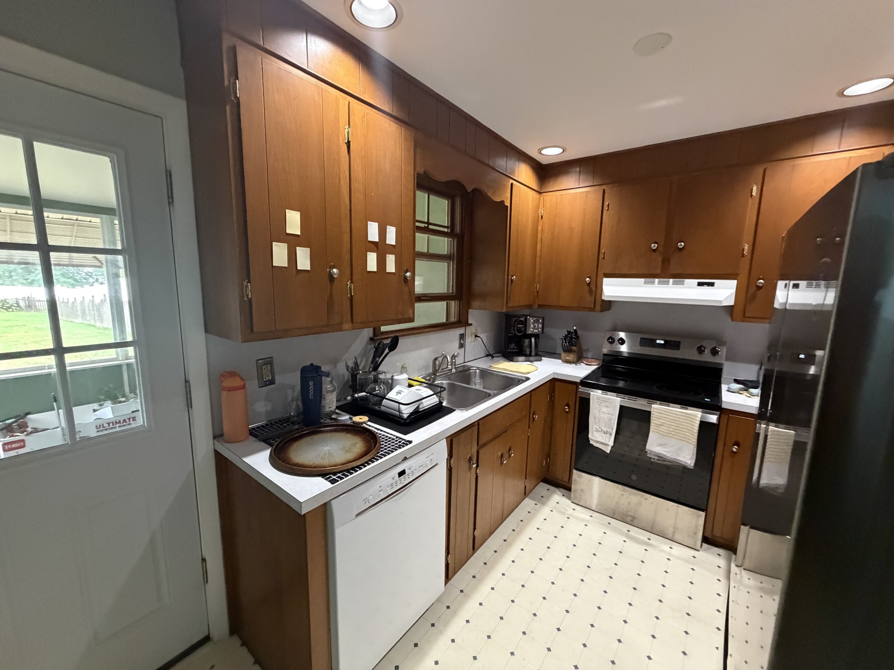Original Royersford kitchen with wood-finish cabinets, light countertops, and white patterned flooring
