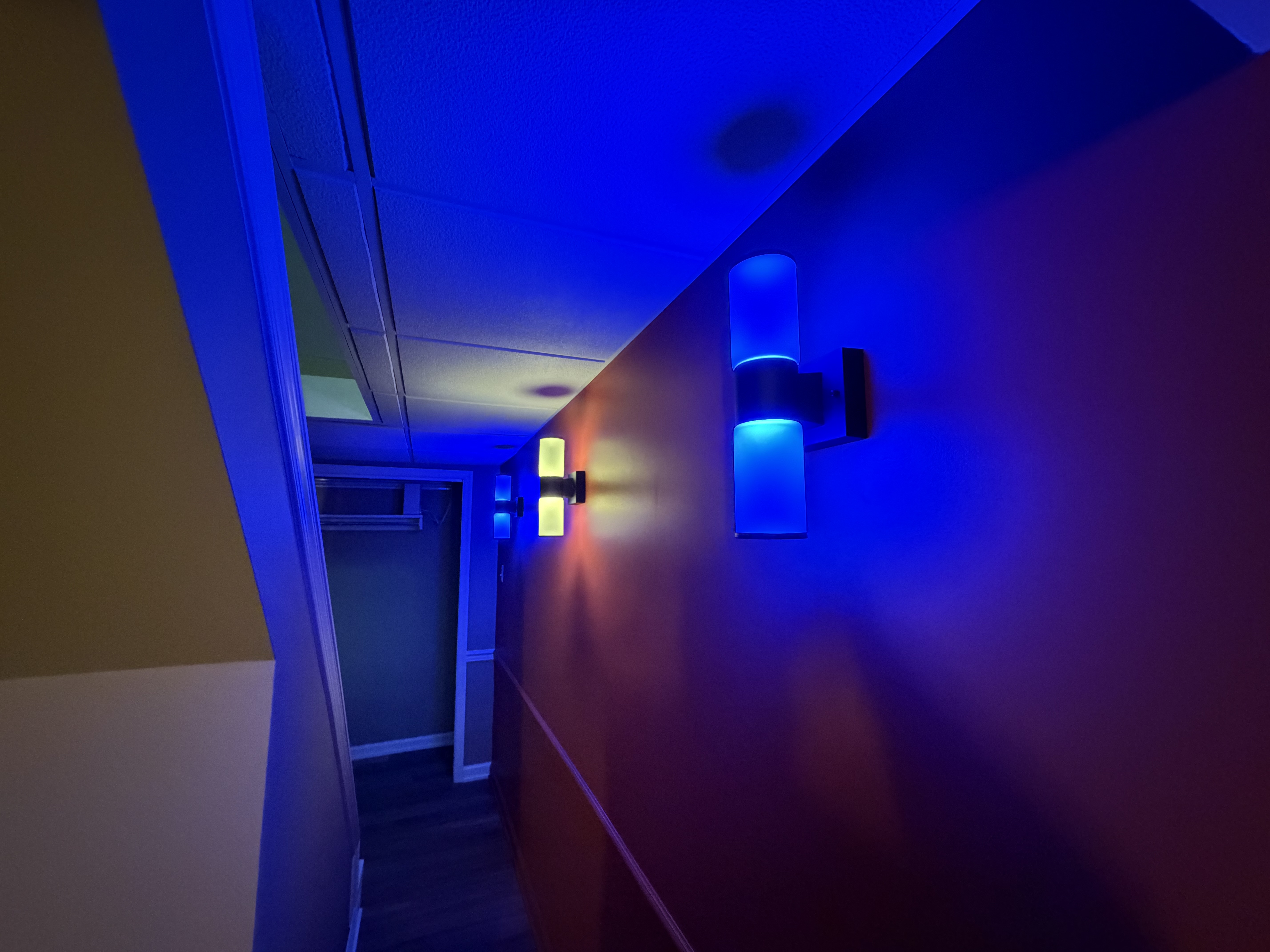 Finished basement hallway with custom wall lighting