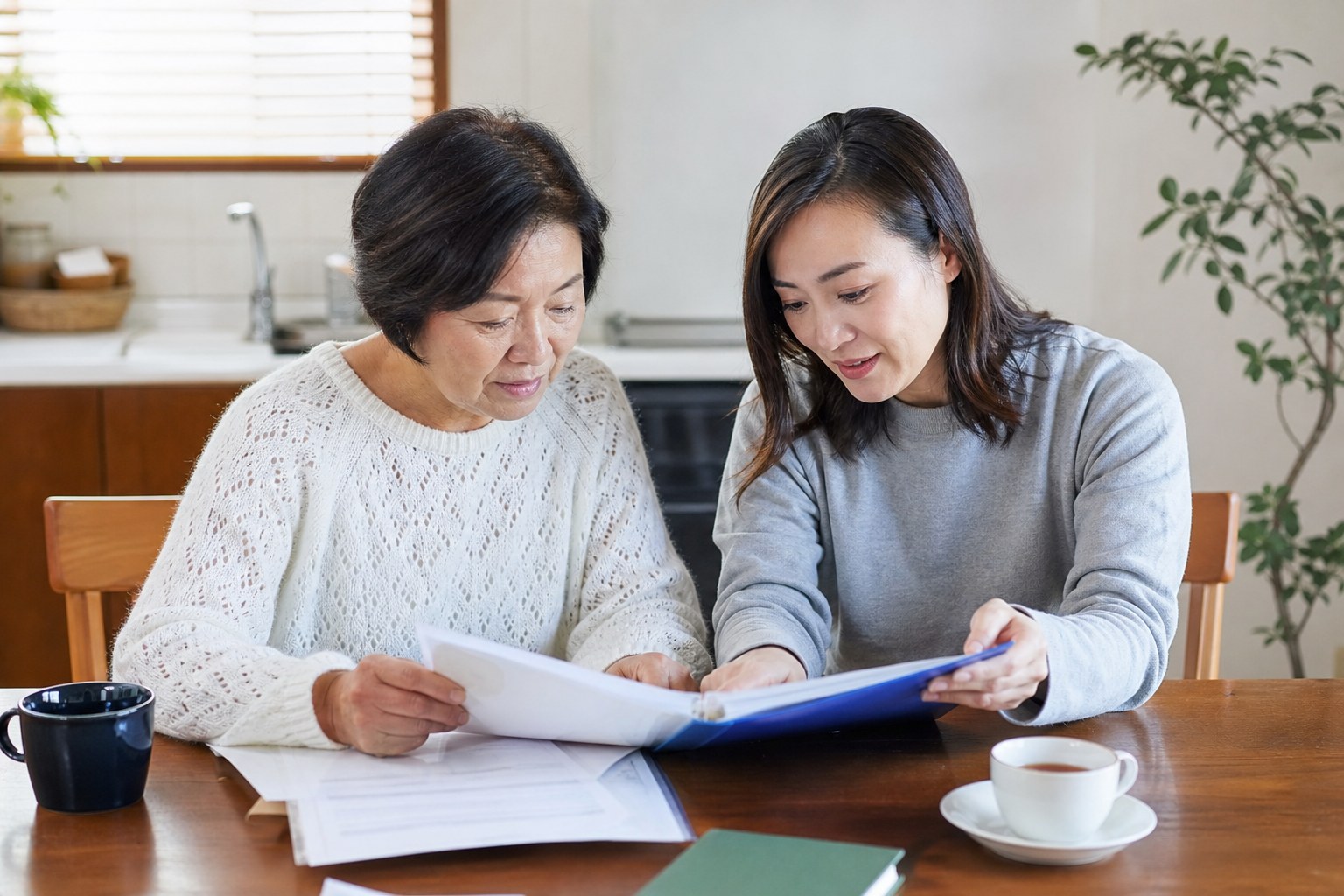 An older adult and adult child reviewing personal planning documents together