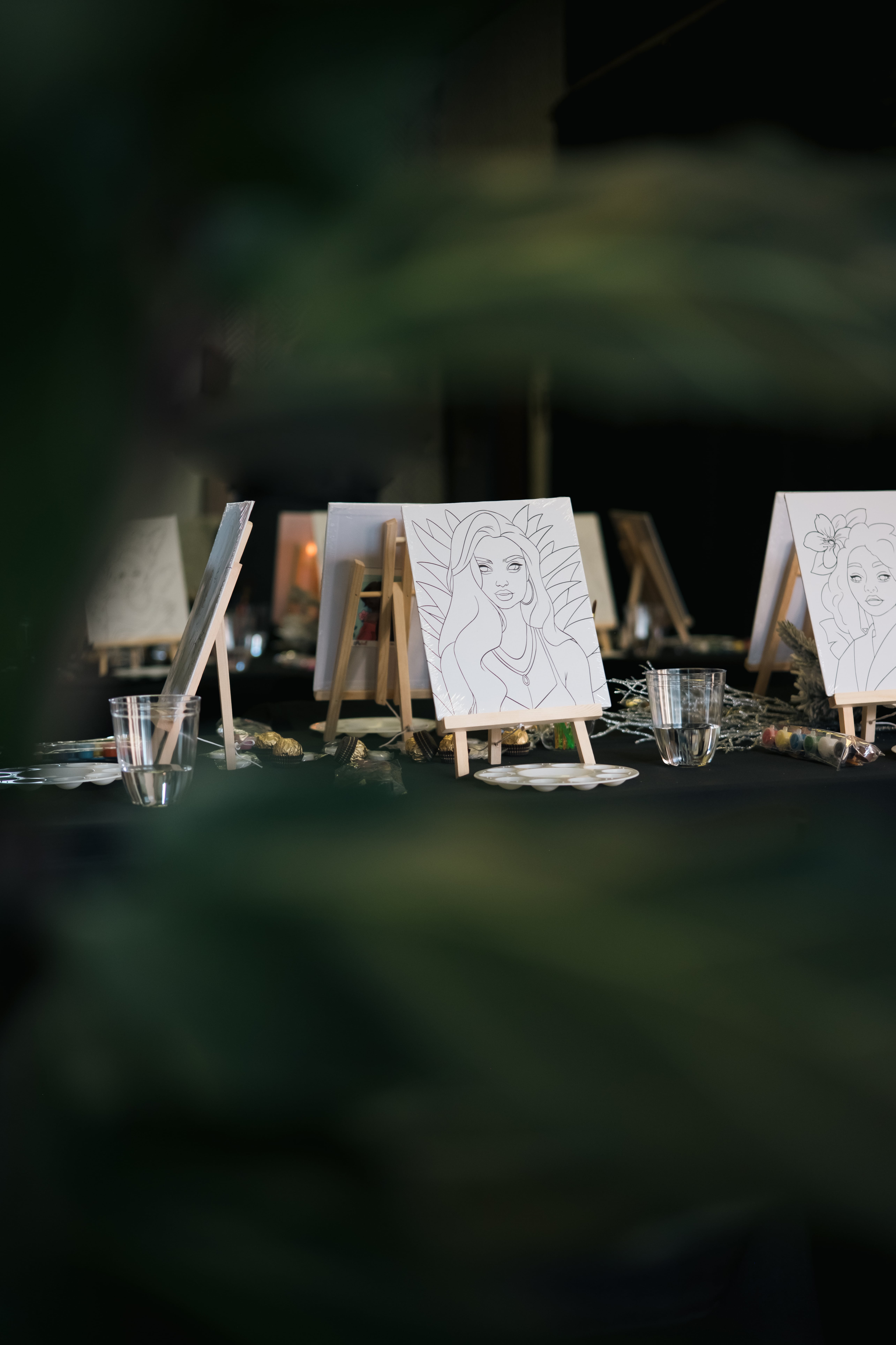 Paint & Sip canvases arranged on easels