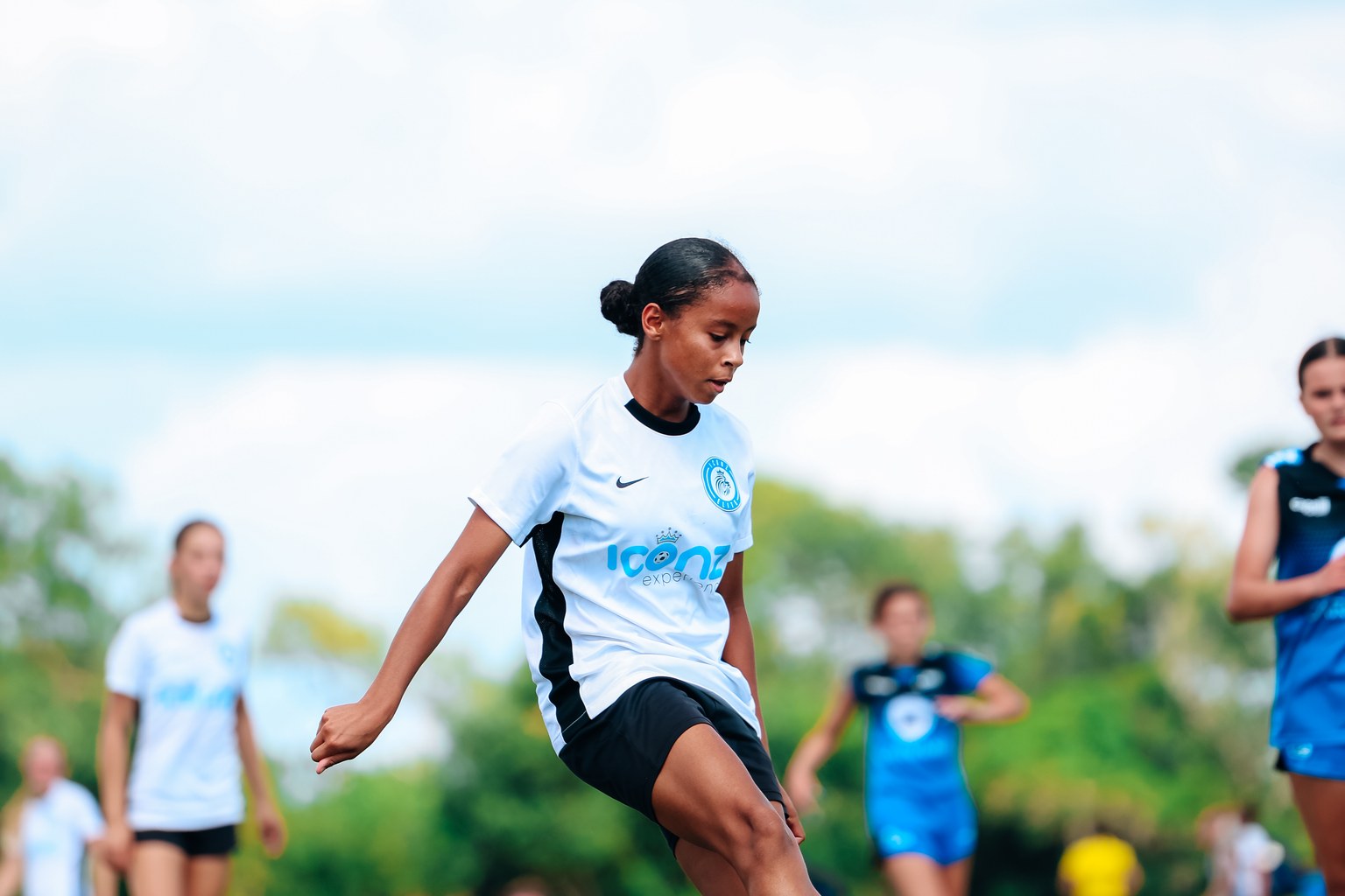 Iconz Elite player changing direction to strike a soccer ball during a game
