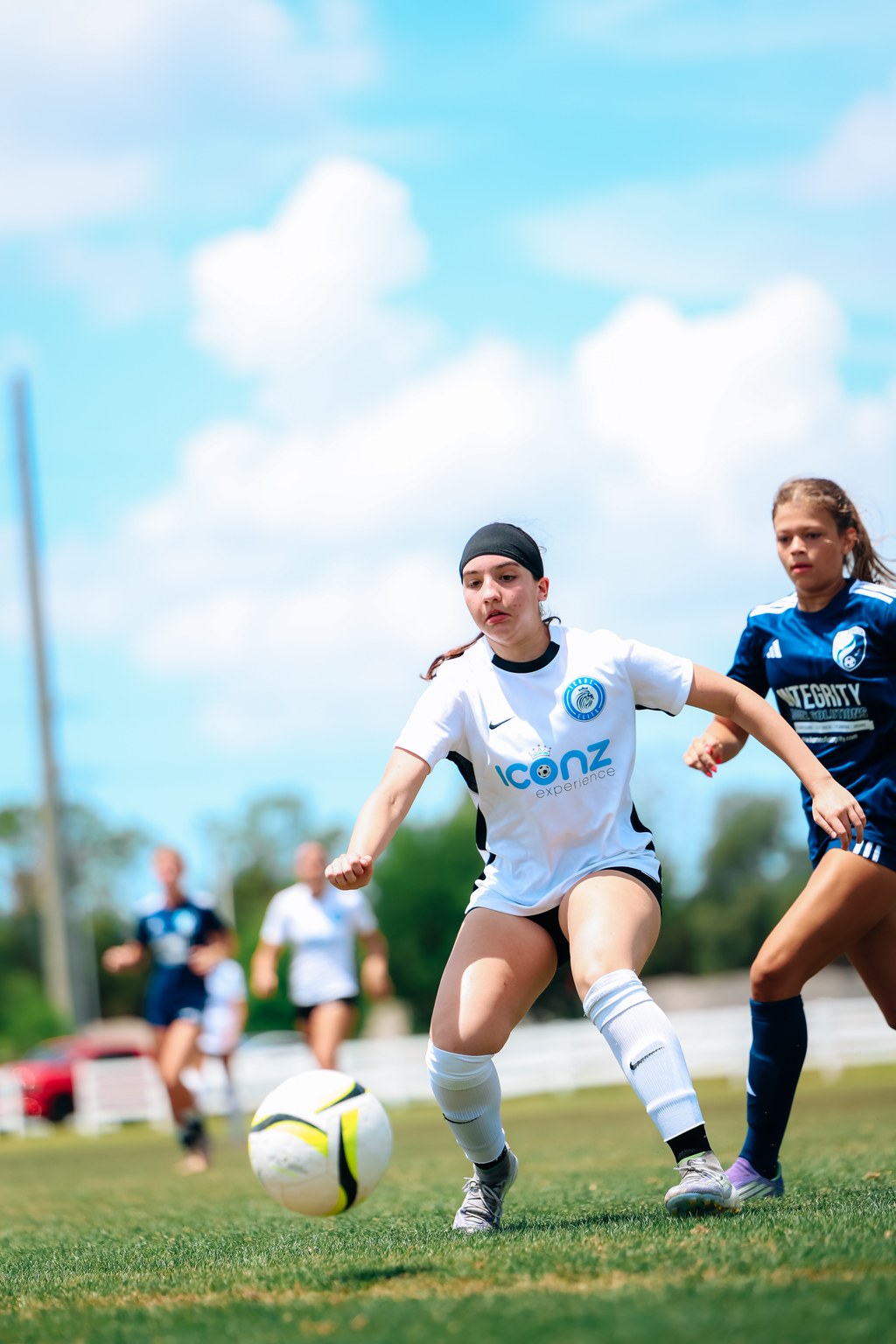 Youth soccer player carrying the ball while an opponent closes space