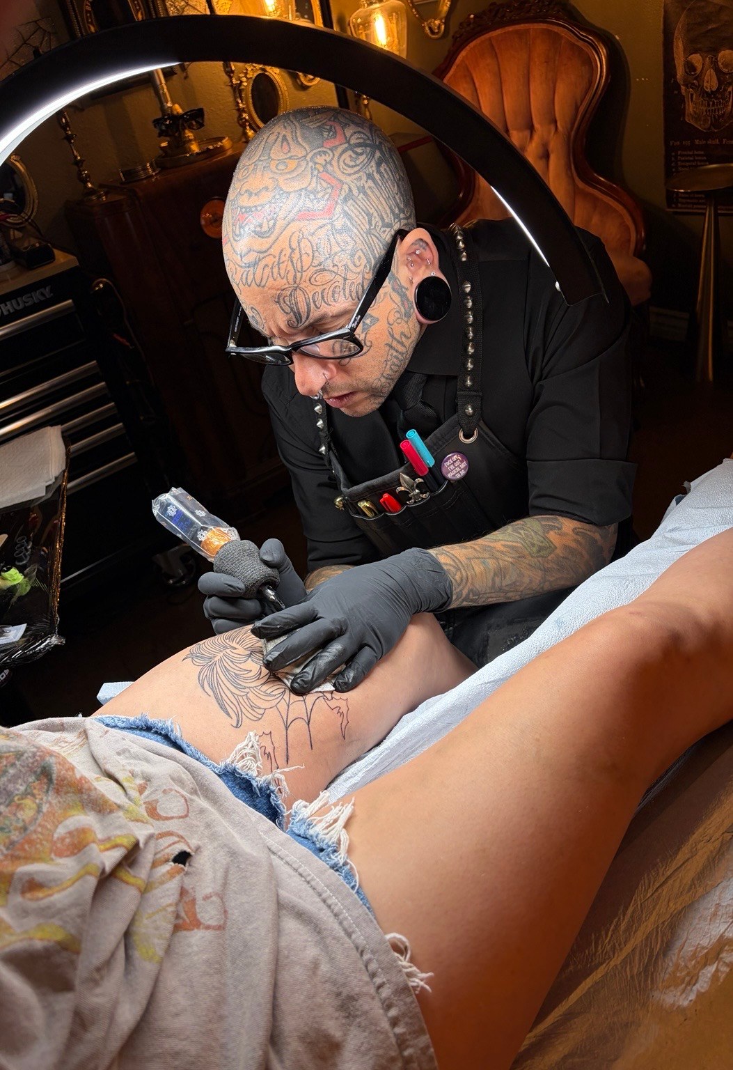 Trent Stone tattooing a client in the private studio
