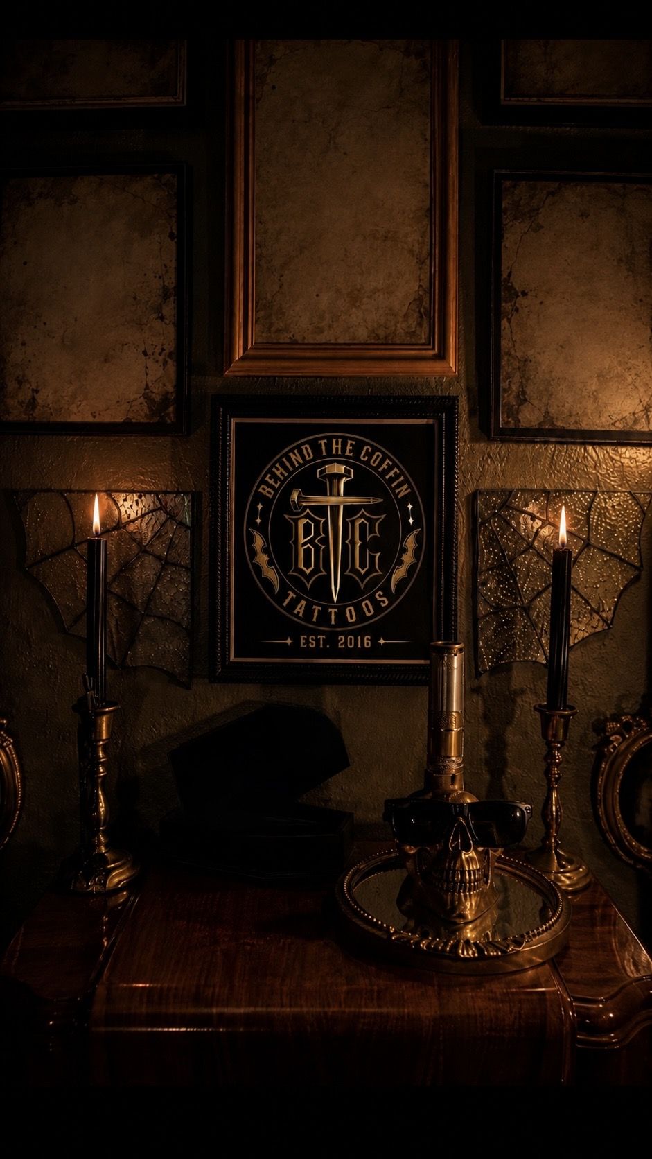 Behind the Coffin Tattoos framed sign with candles and brass details