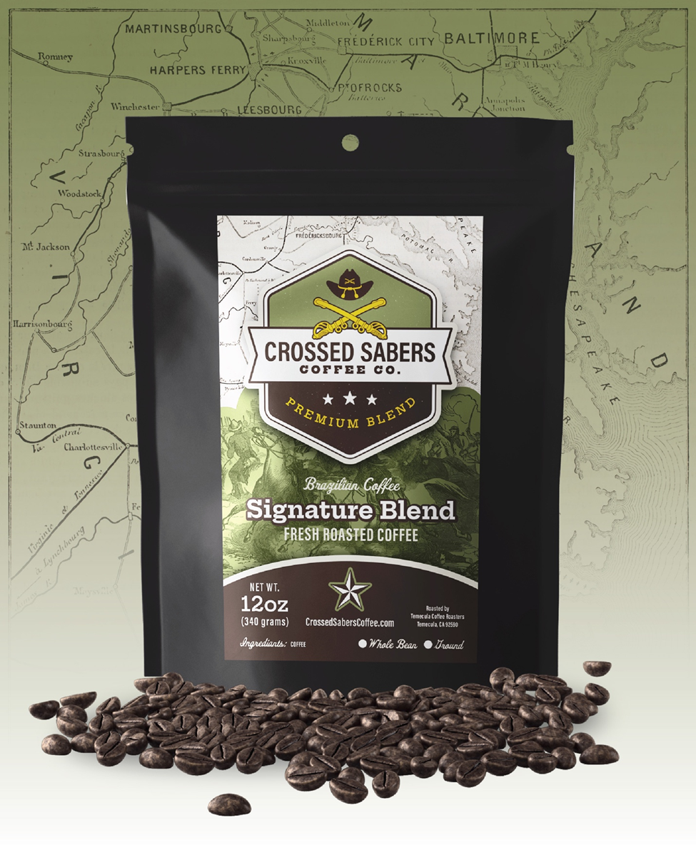 Bag of Crossed Sabers whole bean coffee on a dark wooden table