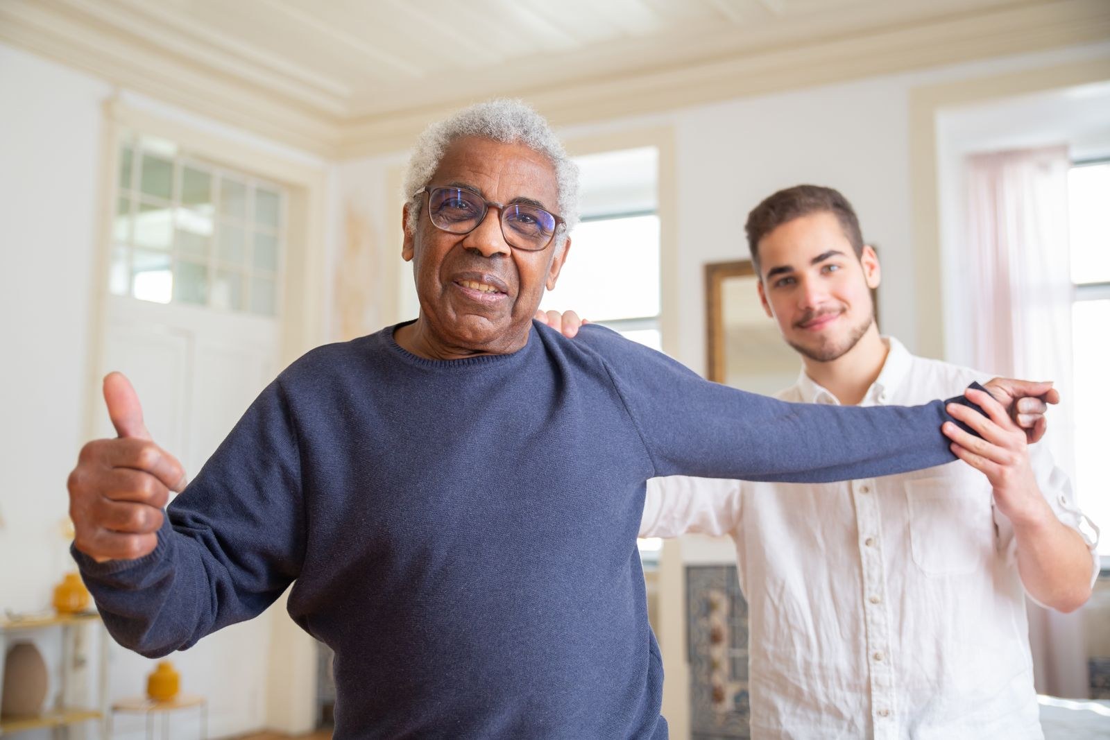 Senior man practicing an arm exercise with support