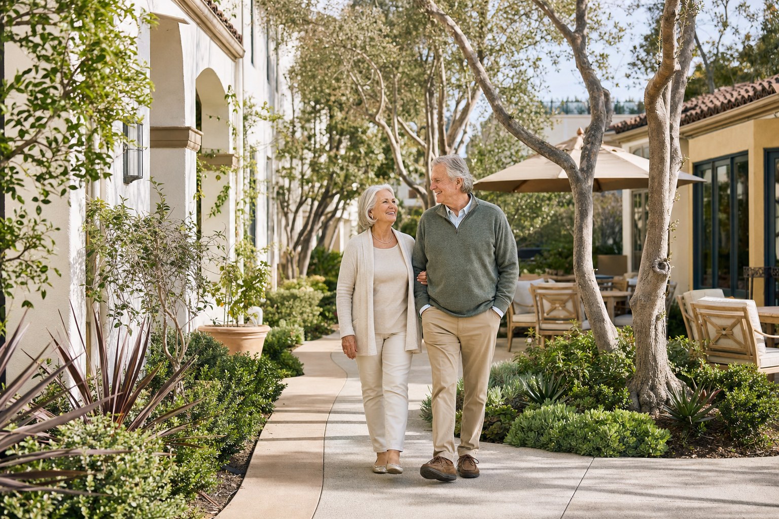 Older couple walking through a bright Southern California senior living courtyard