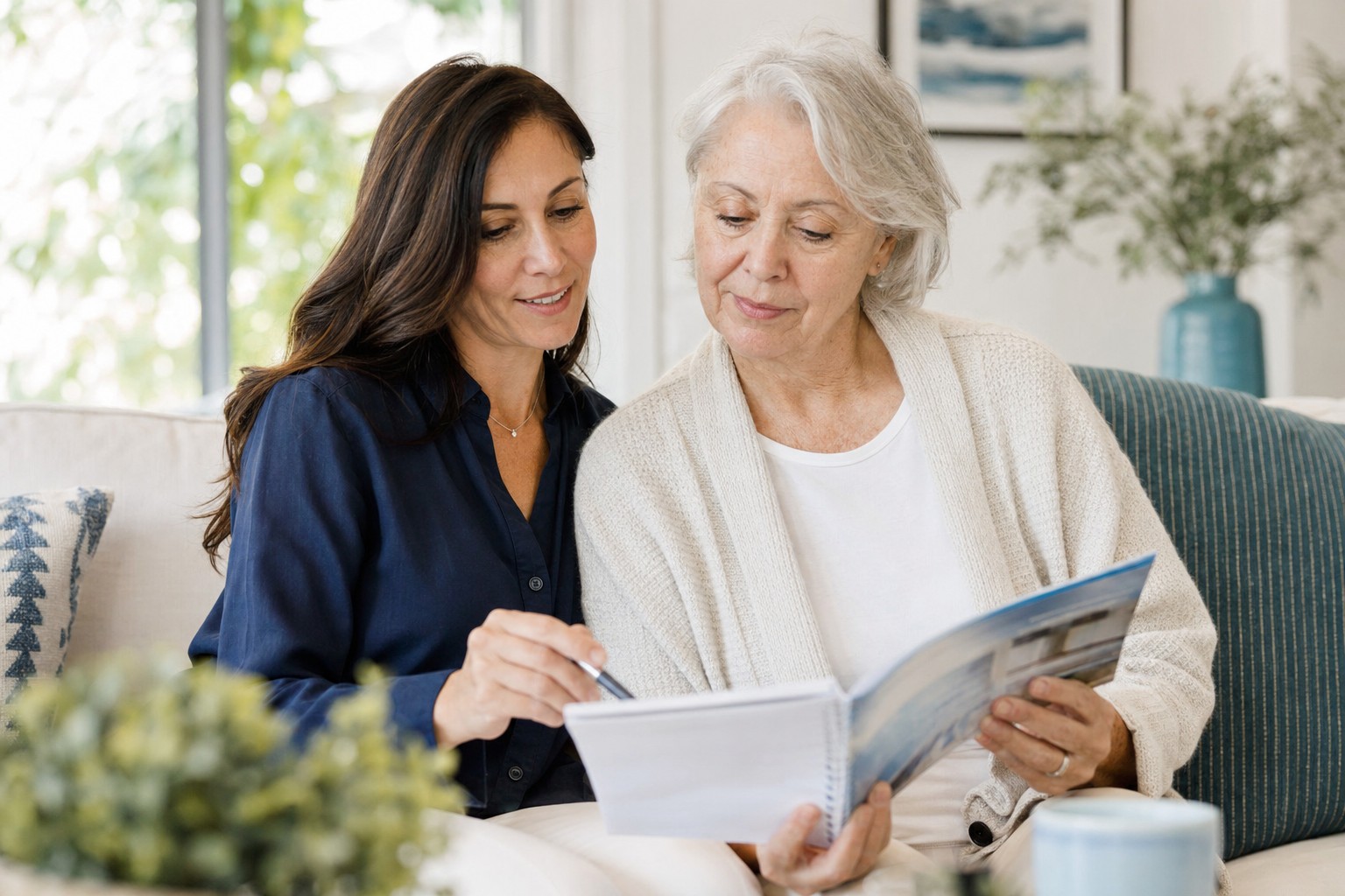 Adult daughter and older parent reviewing memory care information together