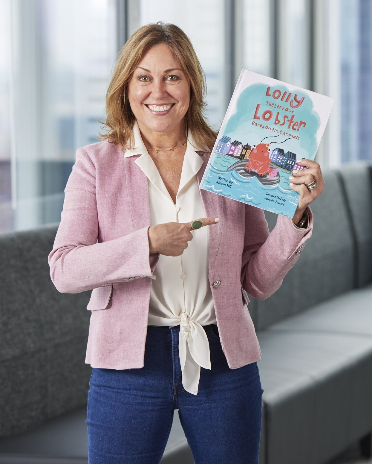 Allison Hill holding her book, Lolly the Leftout Lobster